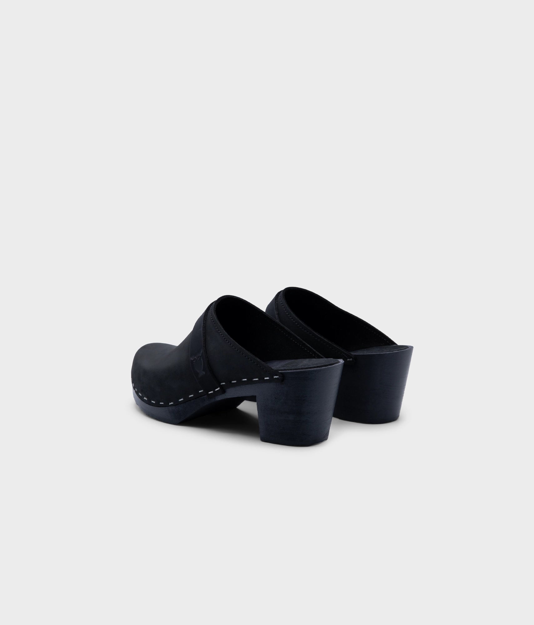 classic high heeled clog mule in black  nubuck leather stapled on a black wooden base with a leather strap