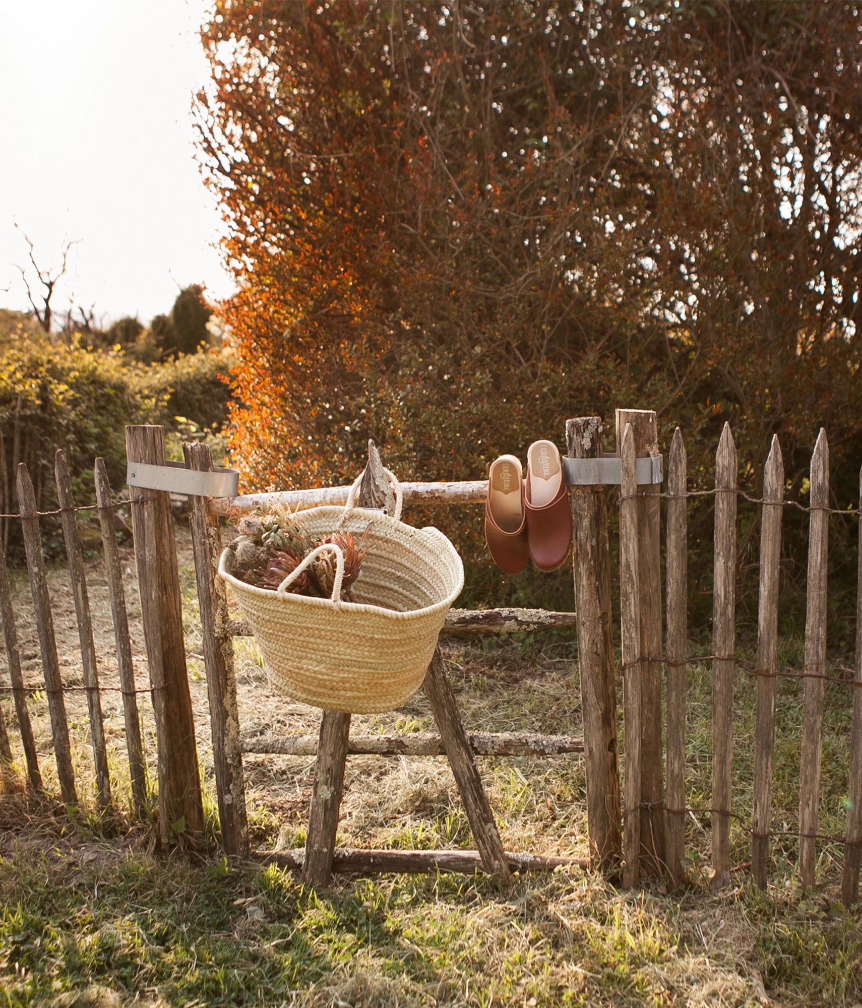 classic high heeled clog mule in cognac red vegetable tanned leather stapled on a light wooden base with a leather strap