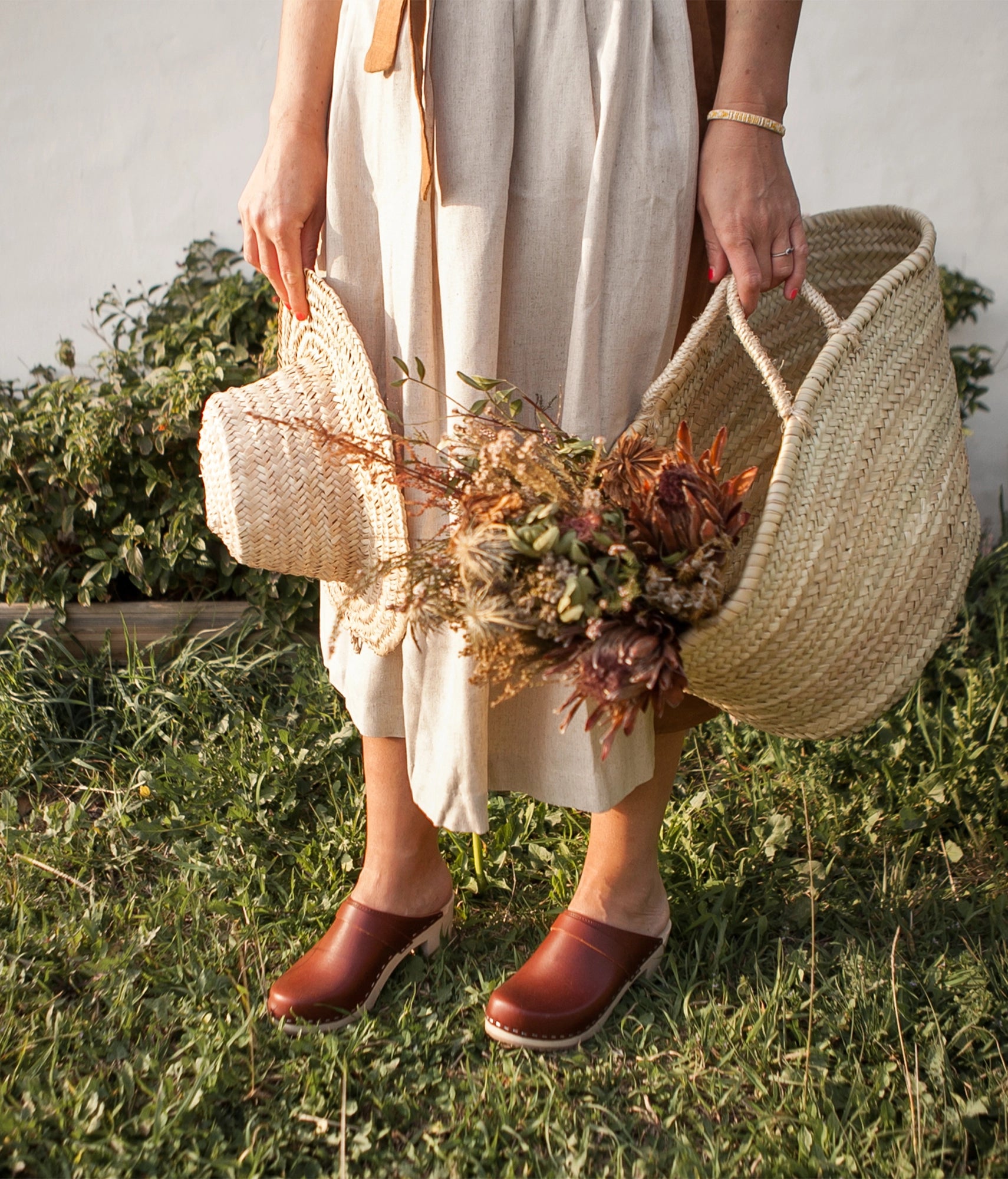 classic high heeled clog mule in cognac red vegetable tanned leather stapled on a light wooden base with a leather strap