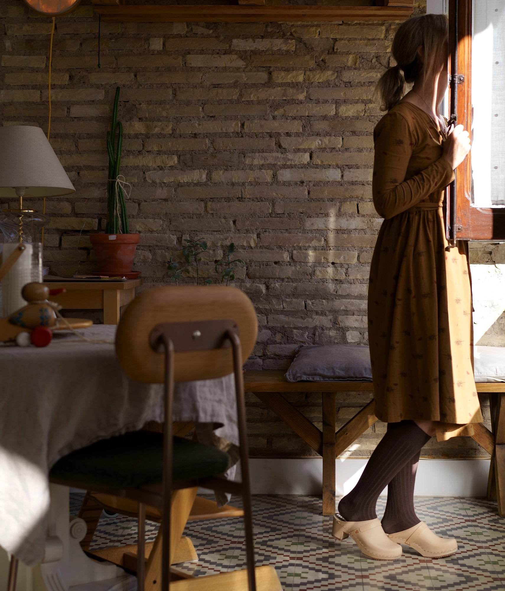 classic high heeled clog mule in ecru beige vegetable tanned leather stapled on a light wooden base with a leather strap
