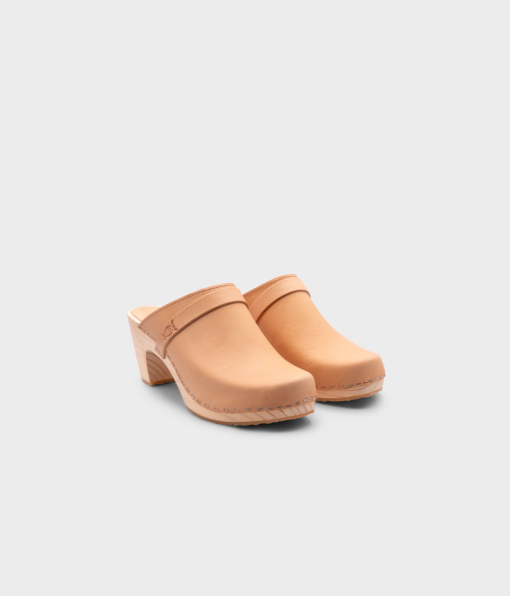 high rise classic clog mule in ecru beige vegetable tanned leather stapled on a light wooden base