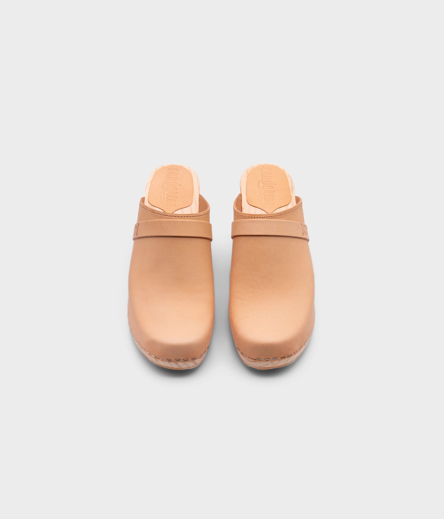high rise classic clog mule in ecru beige vegetable tanned leather stapled on a light wooden base