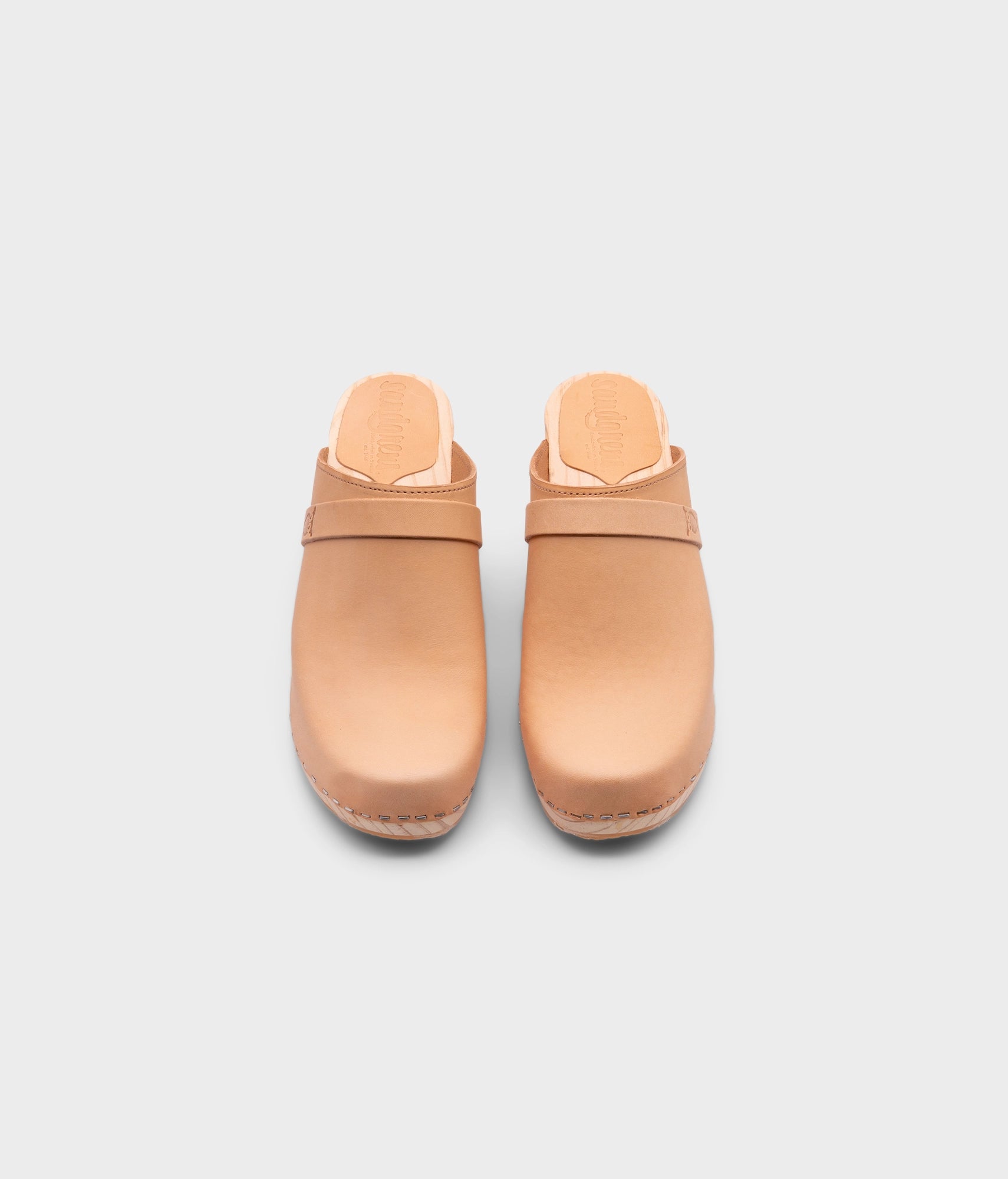 high rise classic clog mule in ecru beige vegetable tanned leather stapled on a light wooden base