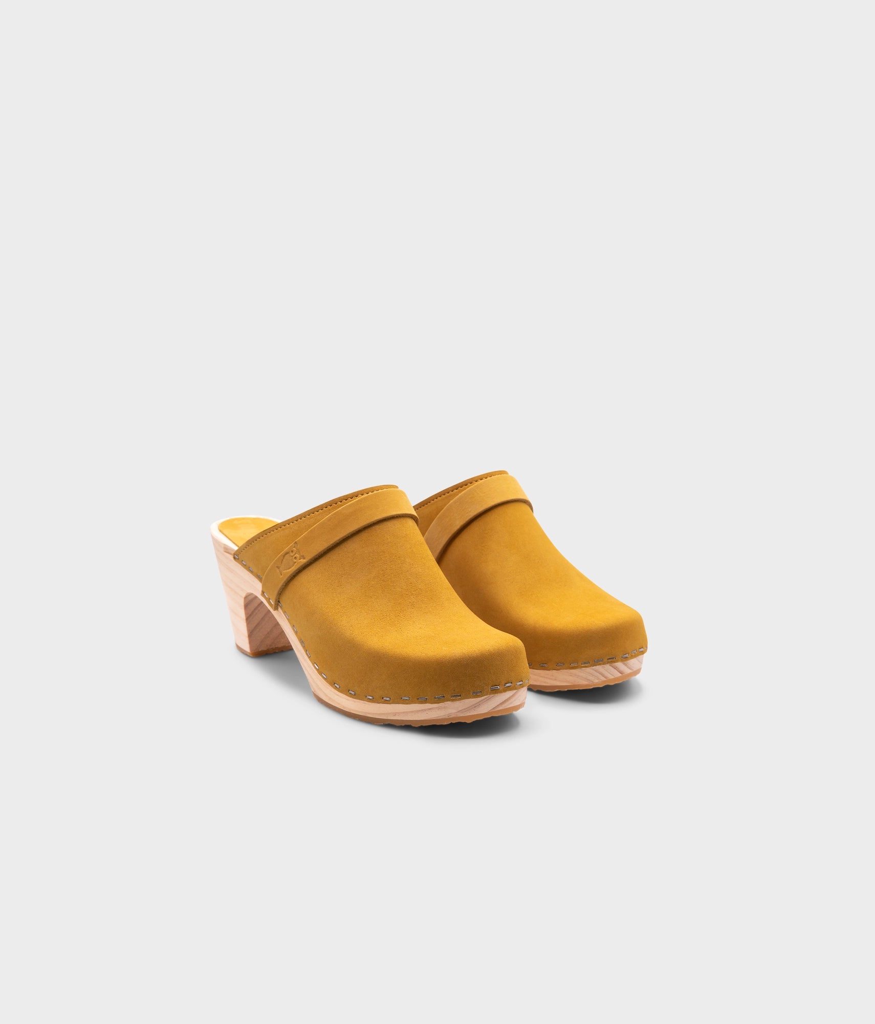 classic high rise heel clog mule in yellow nubuck leather stapled on a light wooden base