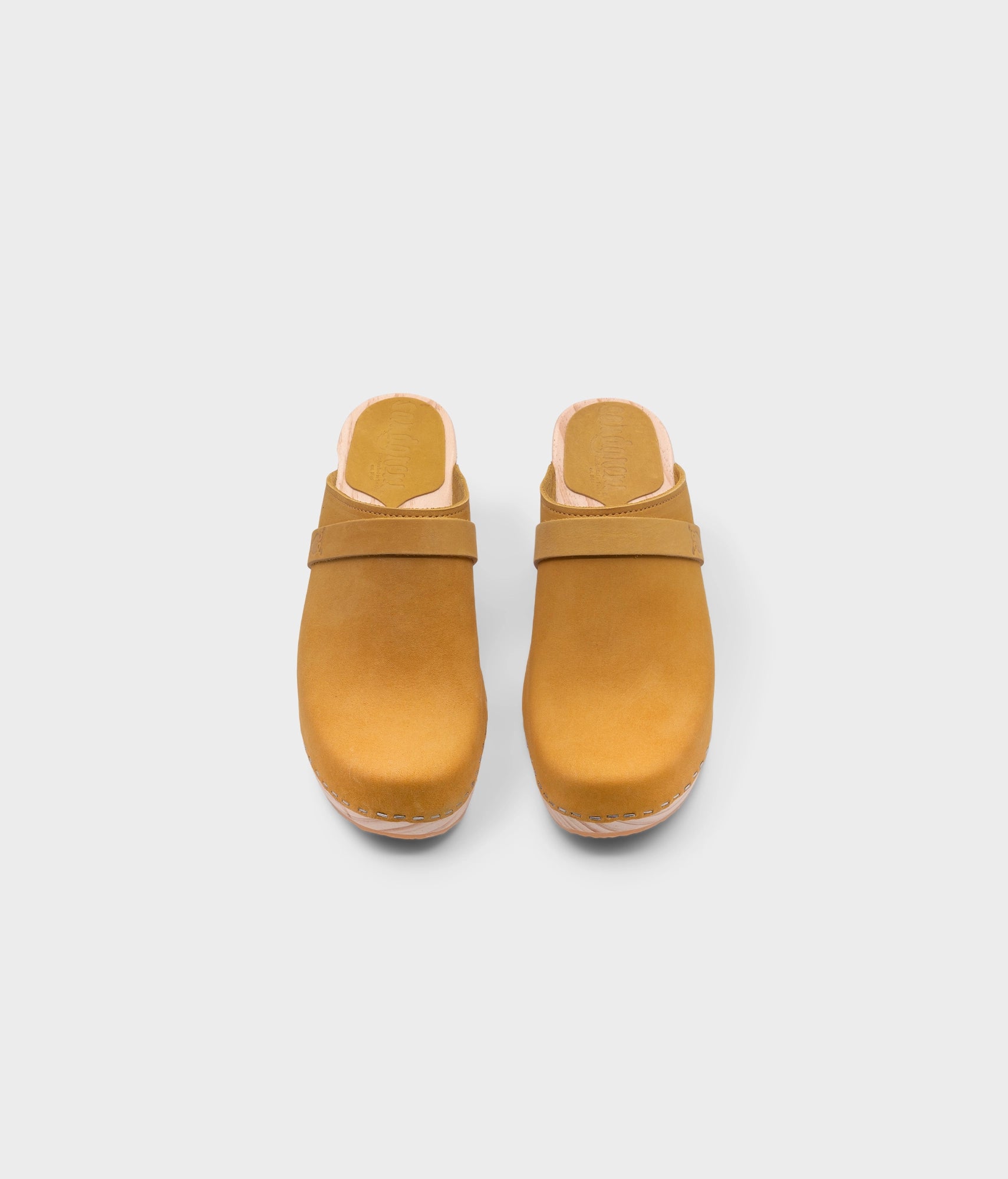 classic high rise heel clog mule in yellow nubuck leather stapled on a light wooden base