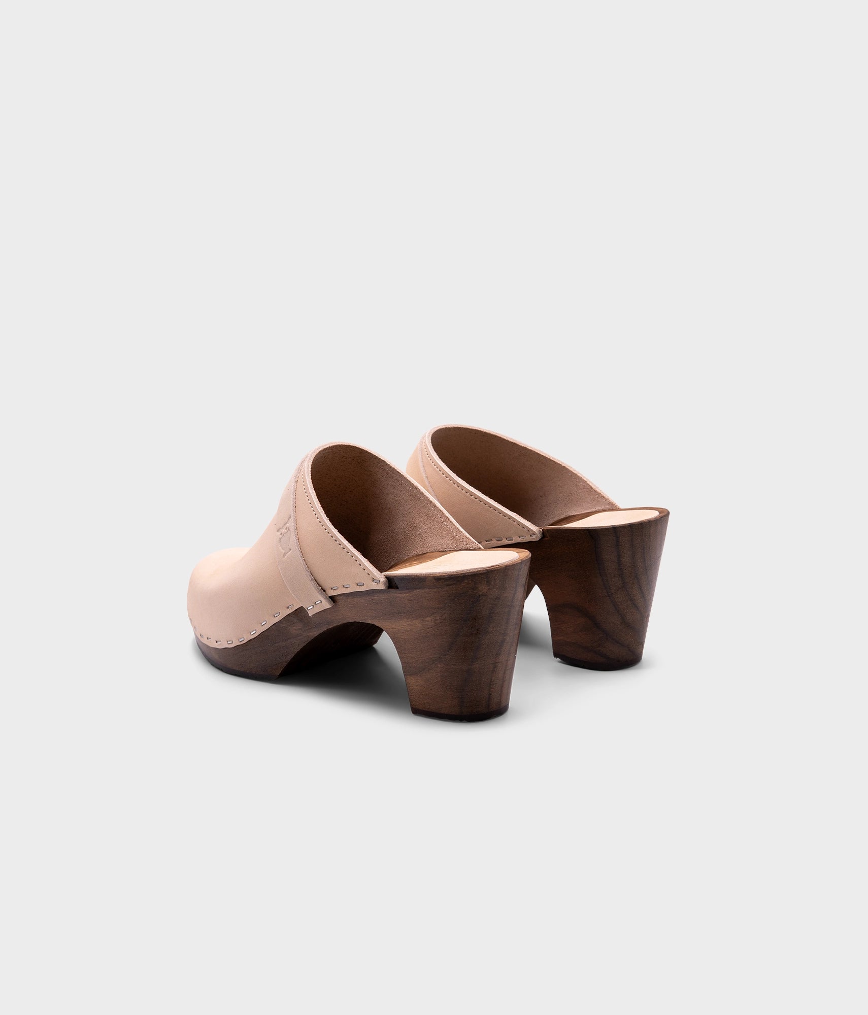 classic high rise heel clog mule in white sand nubuck leather stapled on a dark wooden base