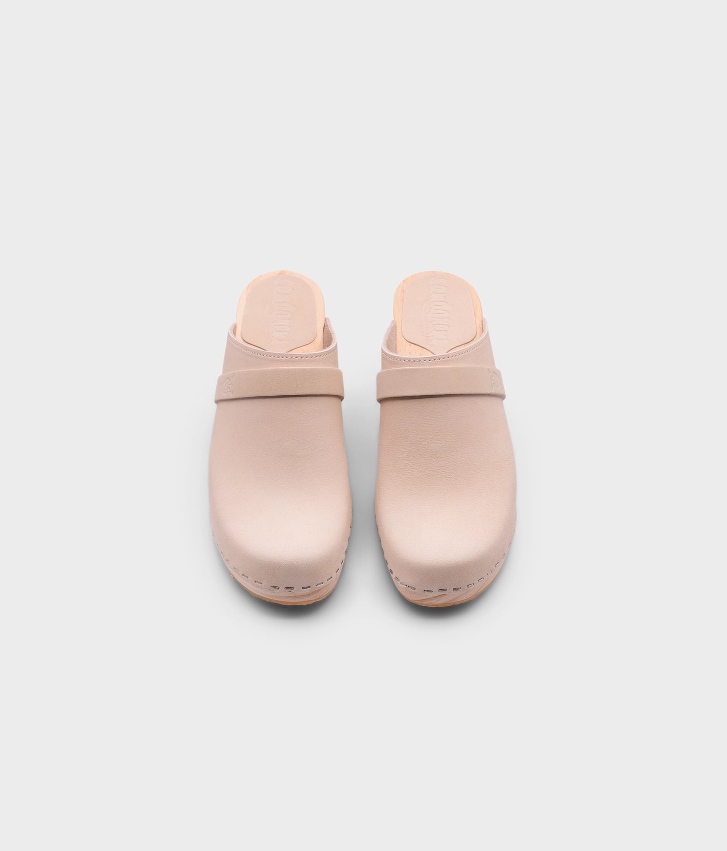 classic high rise heel clog mule in sand white nubuck leather stapled on a light wooden base