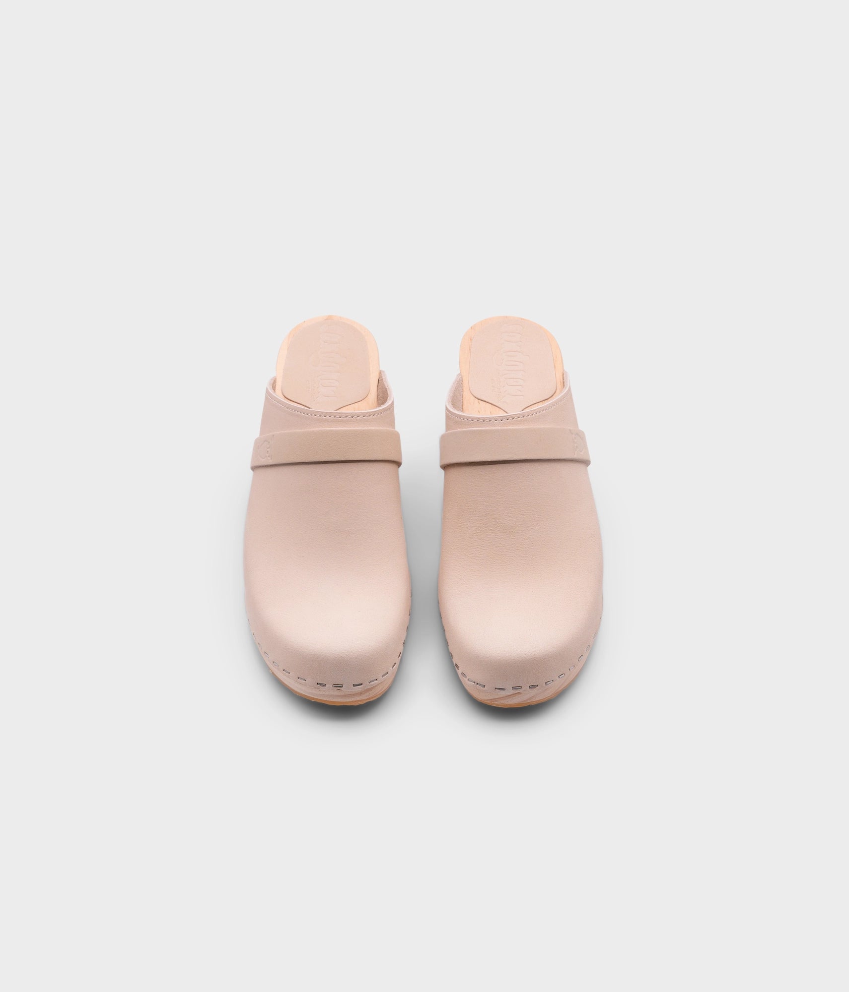 classic high rise heel clog mule in sand white nubuck leather stapled on a light wooden base