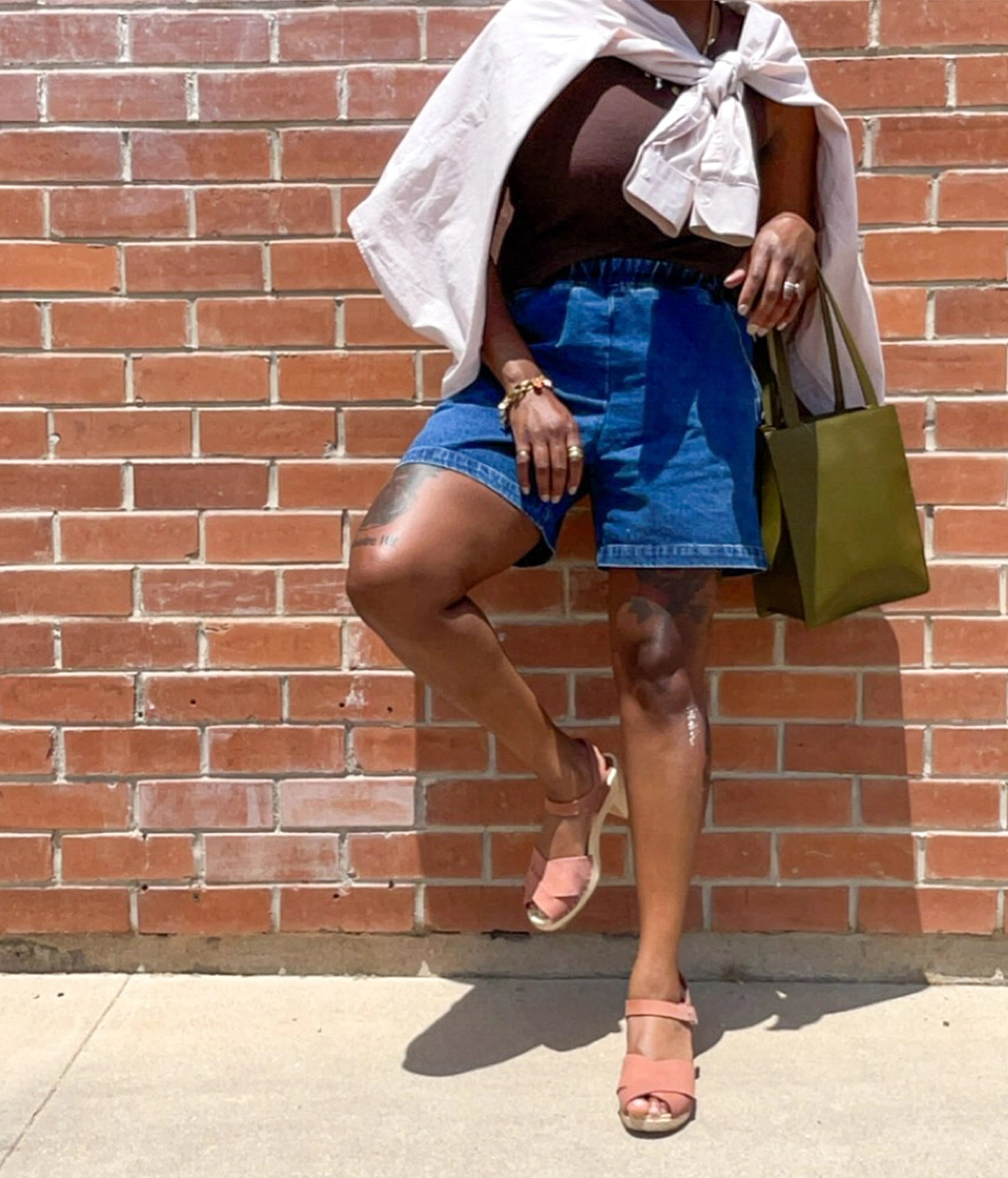 high rise heel crossed clog sandals in blush pink nubuck leather stapled on a light wooden base