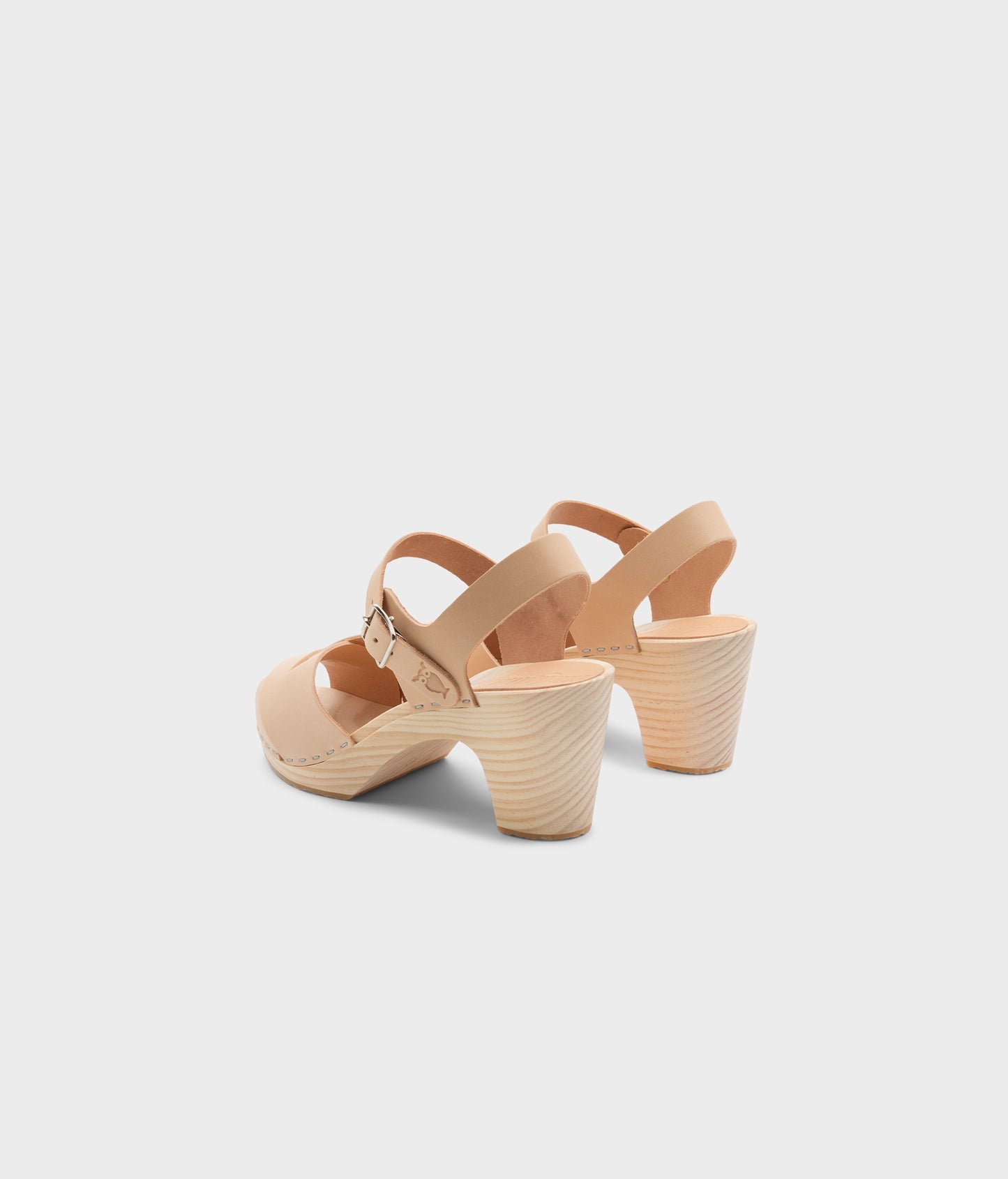 high rise heel crossed clog sandals in ecru beige vegetable tanned leather stapled on a light wooden base