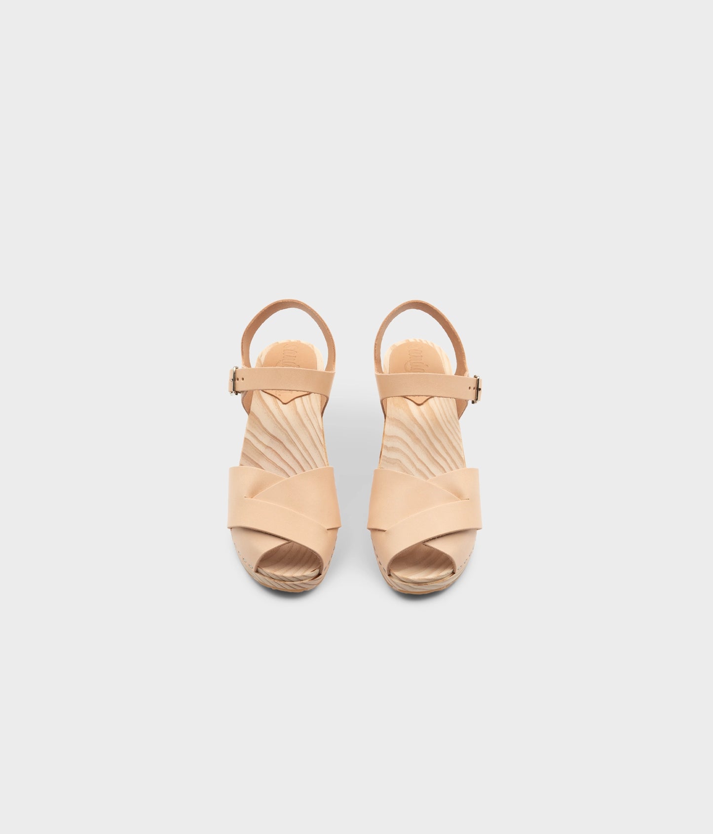 high rise heel crossed clog sandals in ecru beige vegetable tanned leather stapled on a light wooden base