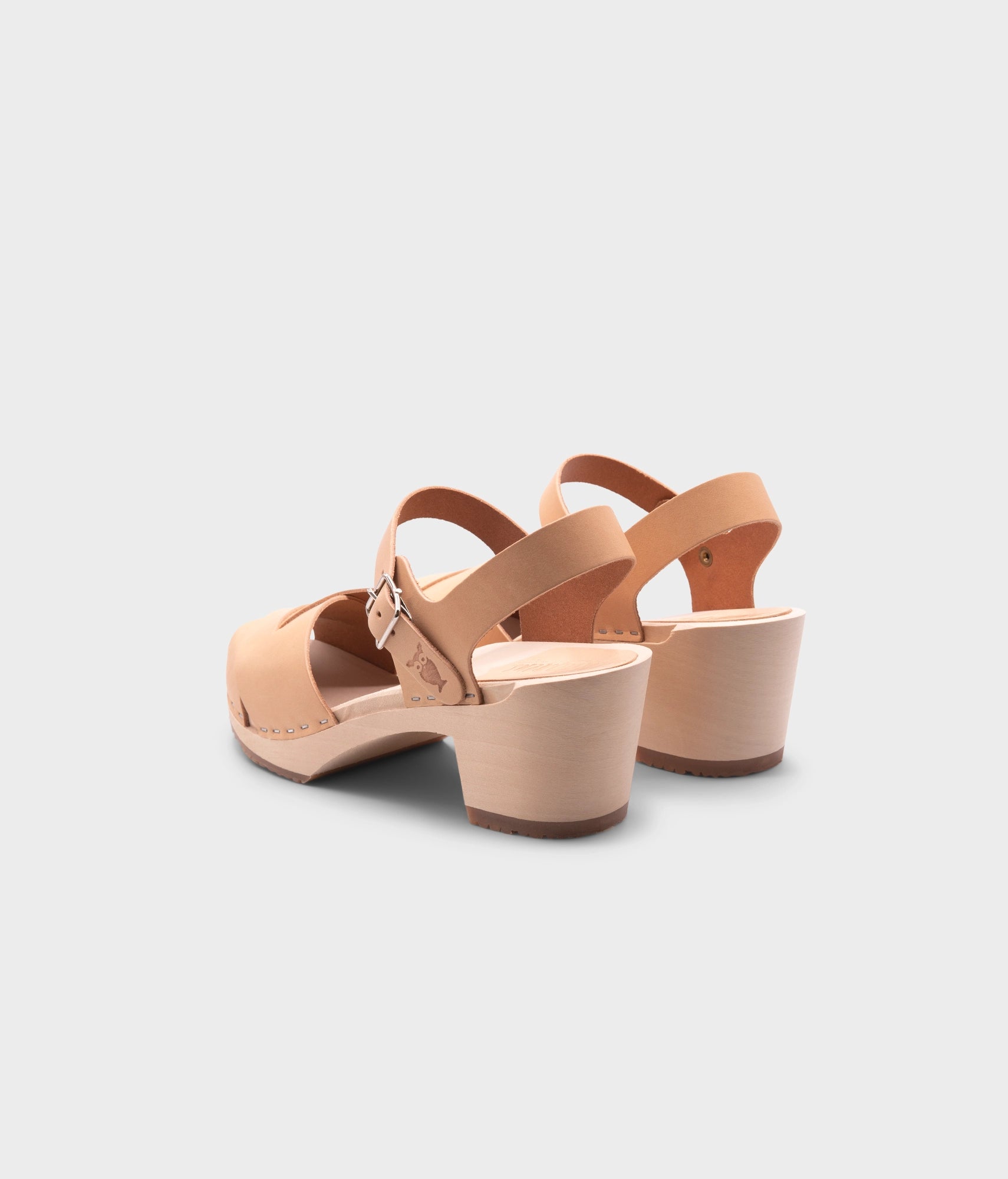 high heeled clog sandals in ecru beige vegetable tanned leather with an open-toe stapled on a light wooden base