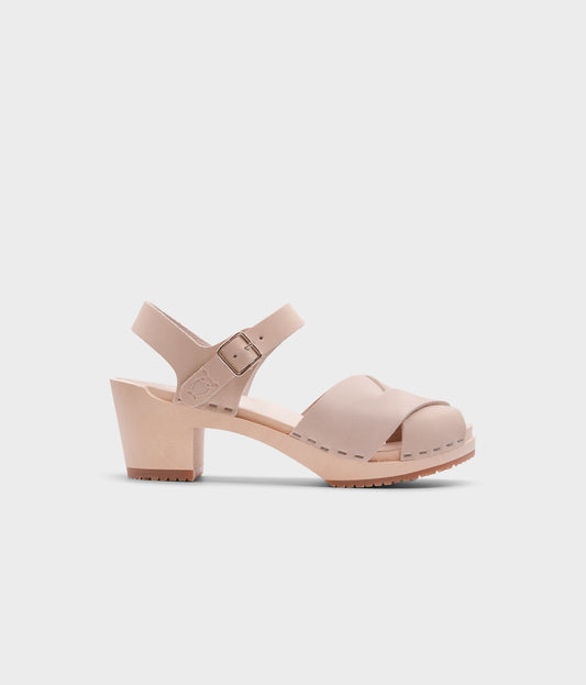 high heeled clog sandals in sand white nubuck leather with an open-toe stapled on a light wooden base