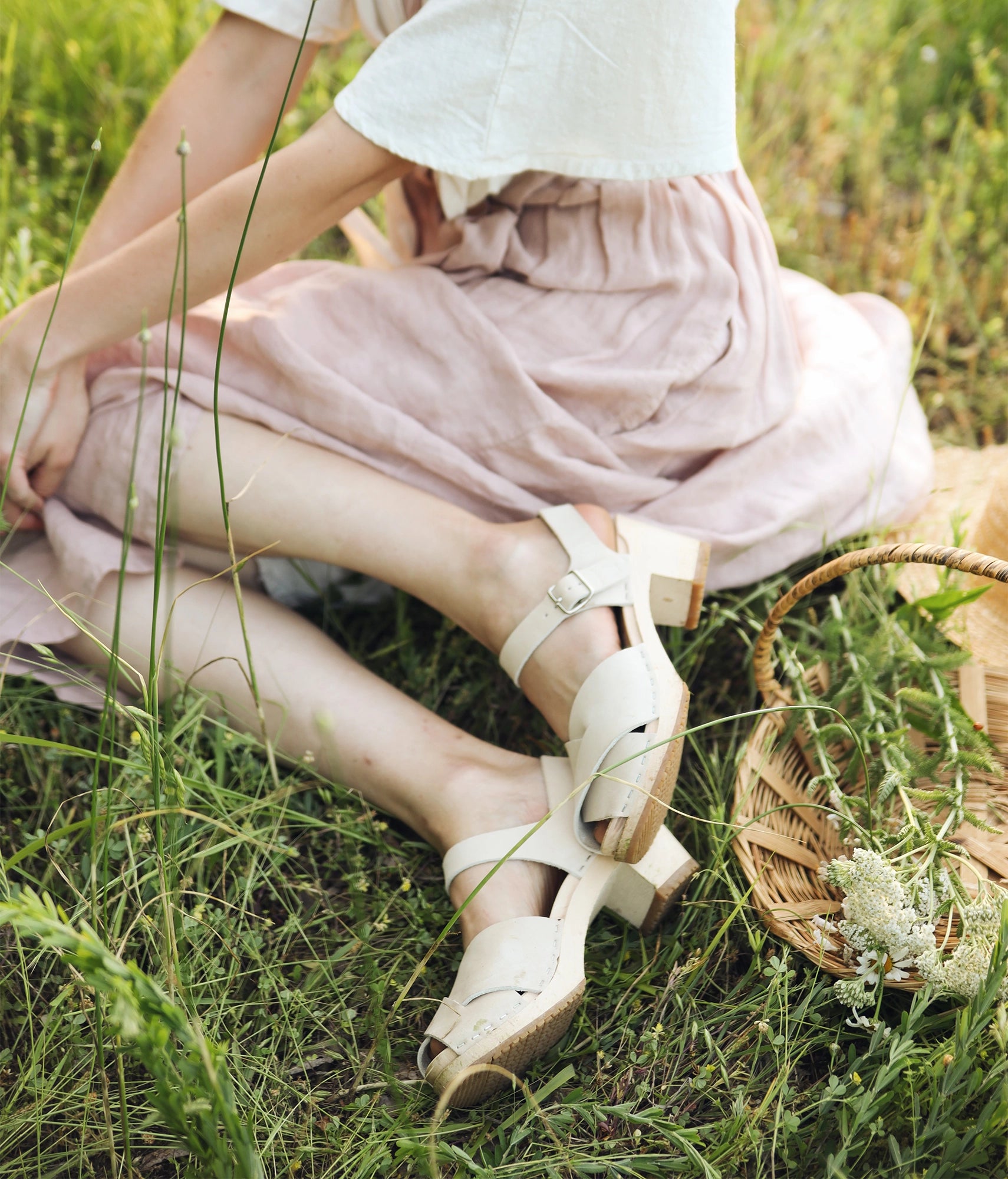 high heeled clog sandals in sand white nubuck leather with an open-toe stapled on a light wooden base