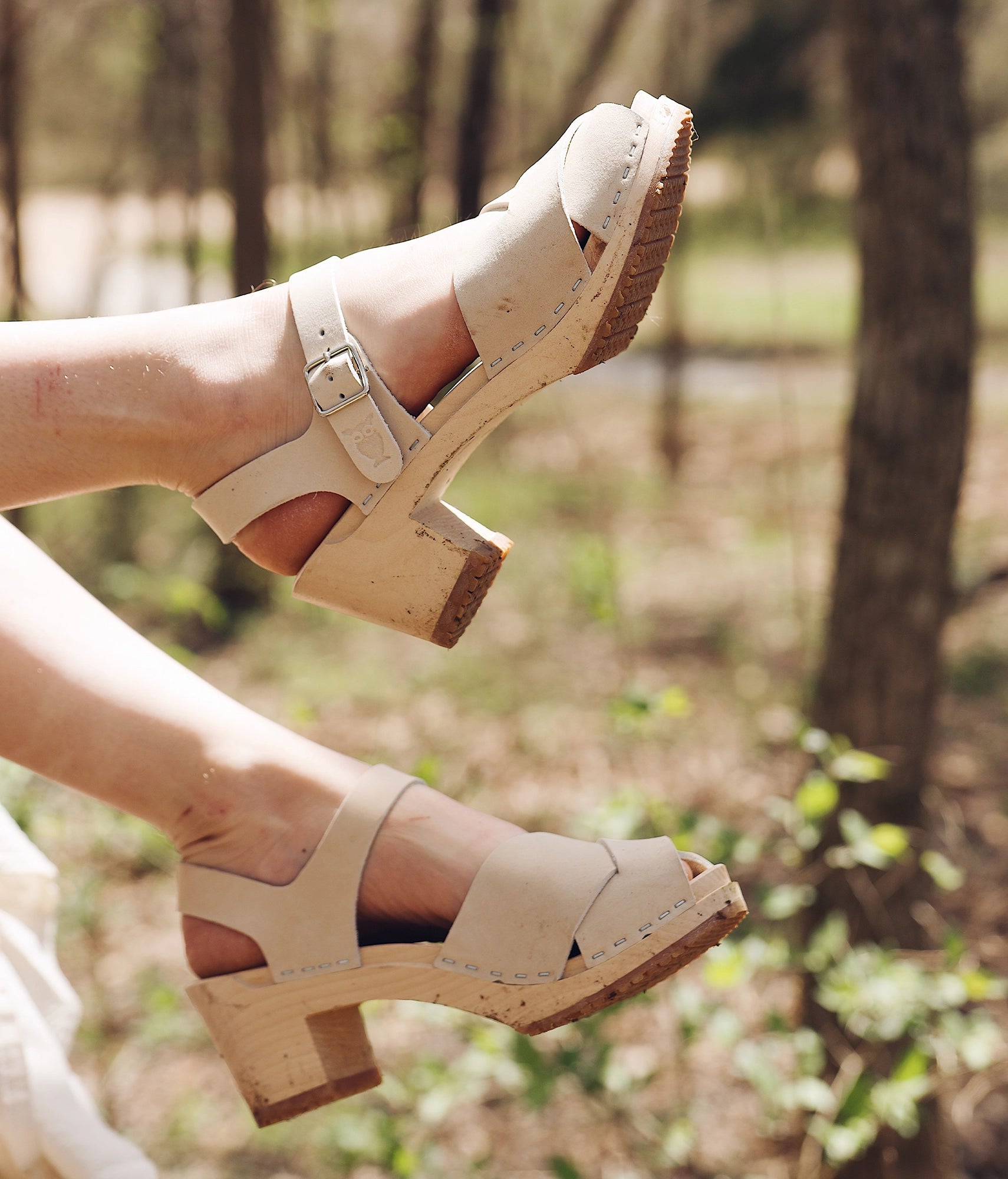 high heeled clog sandals in sand white nubuck leather with an open-toe stapled on a light wooden base