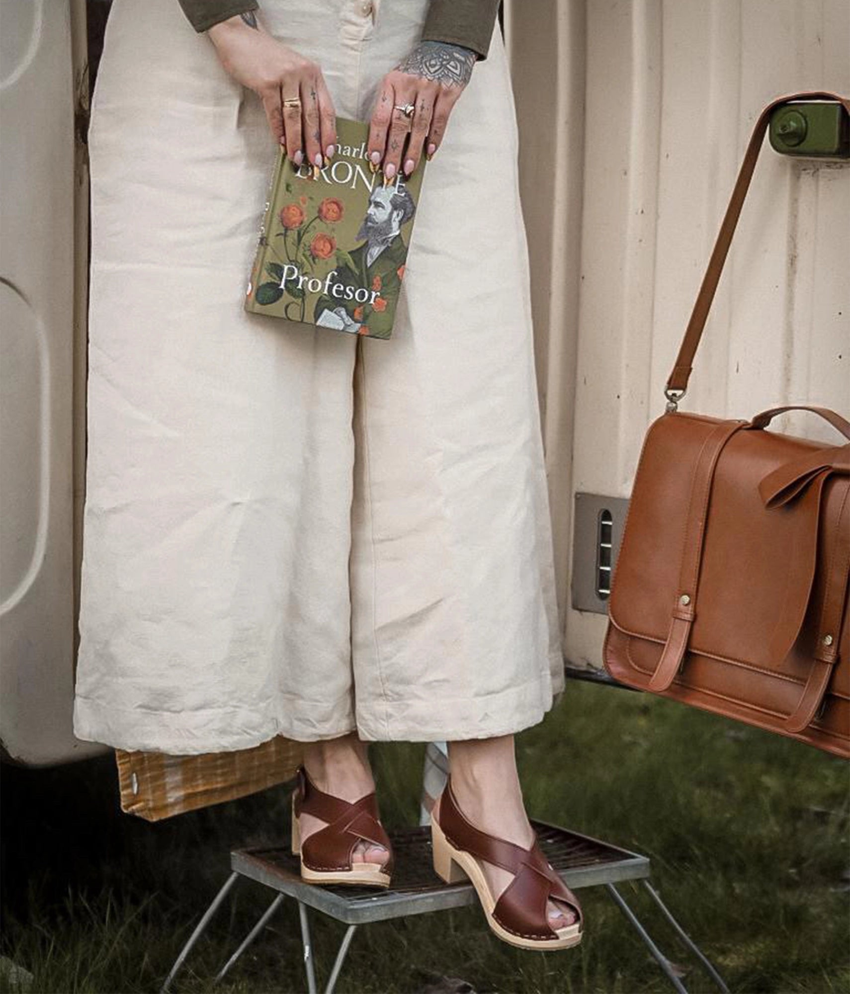 high heeled criss cross clog sandals in cognac red vegetable tanned leather stapled on a light wooden base