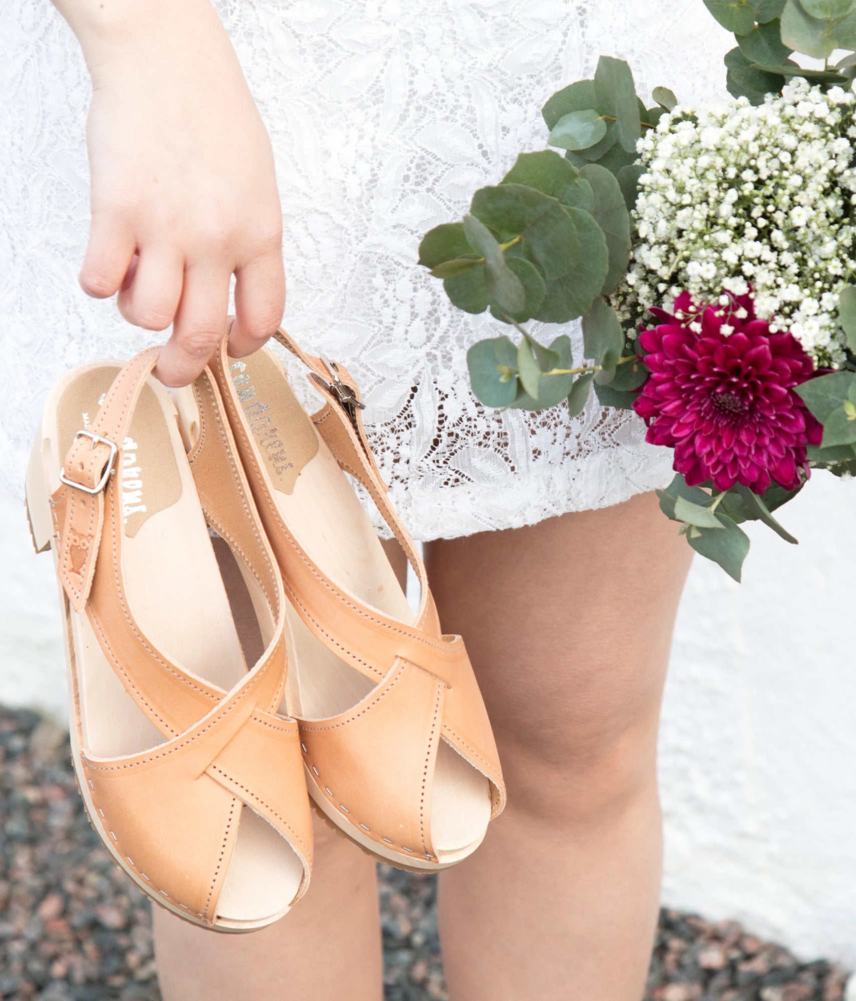 high heeled criss cross clog sandals in ecru beige vegetable tanned leather stapled on a light wooden base