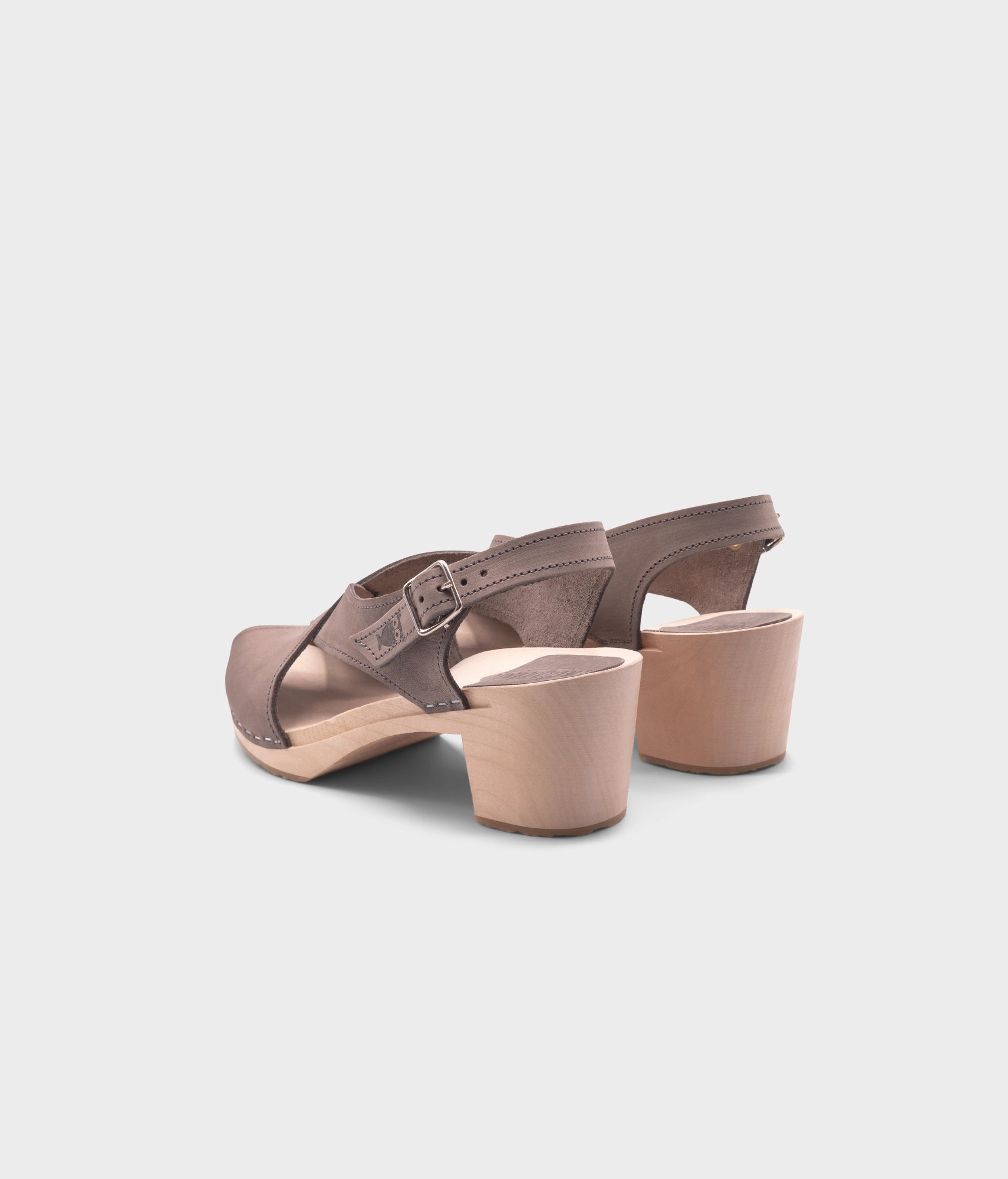 high heeled criss cross clog sandals in stone grey nubuck leather stapled on a light wooden base