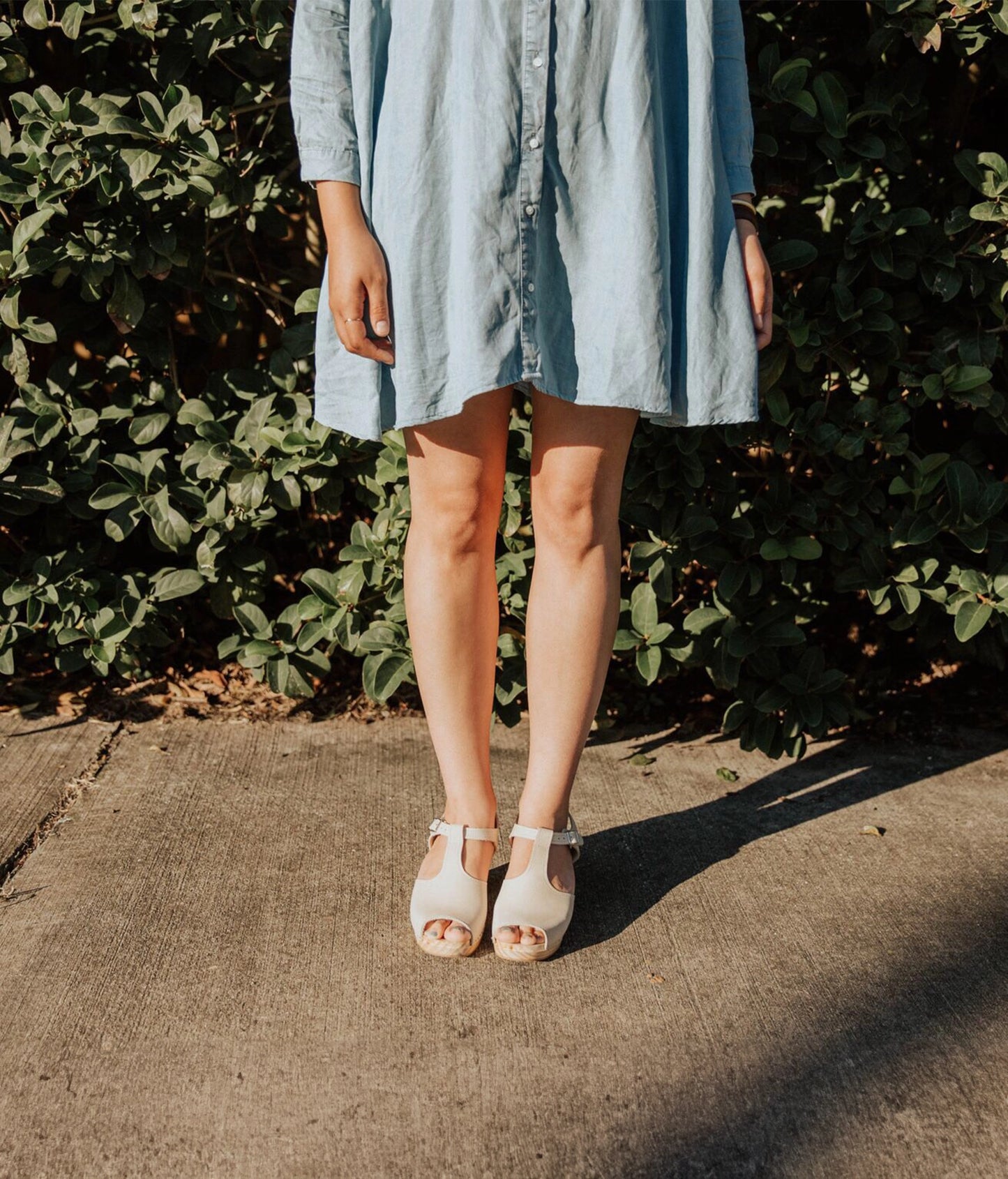 high rise heeled open toe clog sandal in sand white nubuck leather stapled on a light wooden base