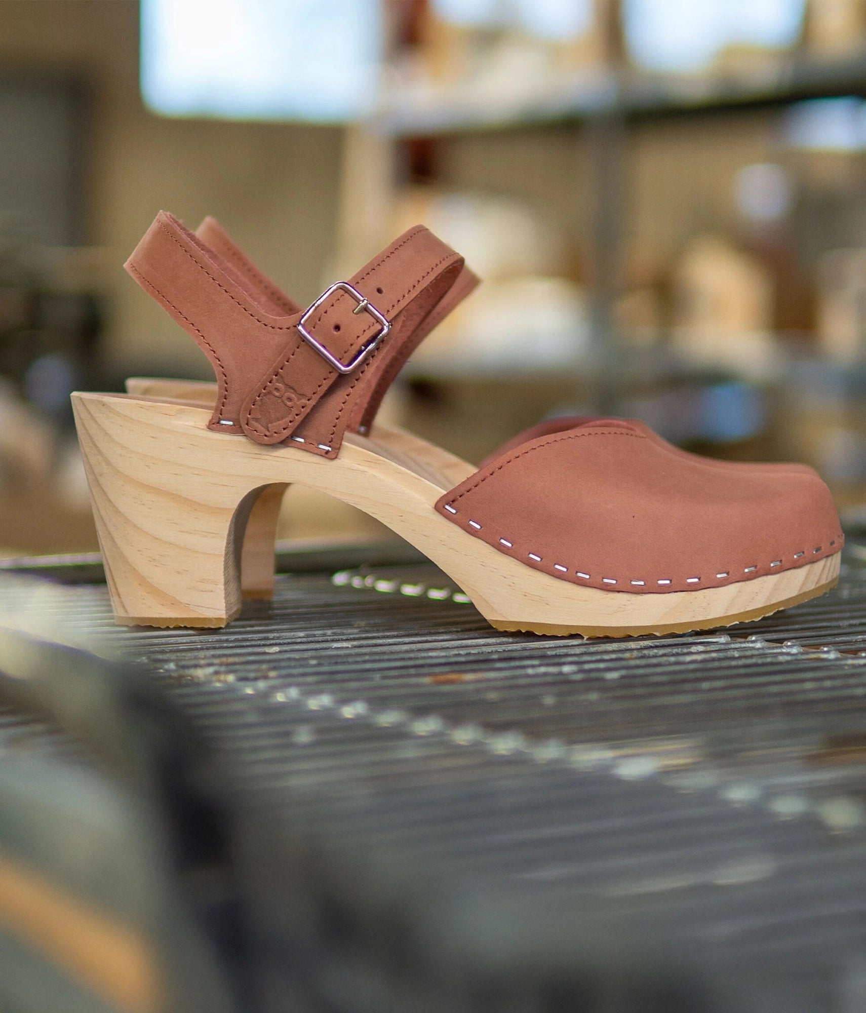 High rise heel classic clog sandals in blush pink nubuck leather stapled on a light wooden base