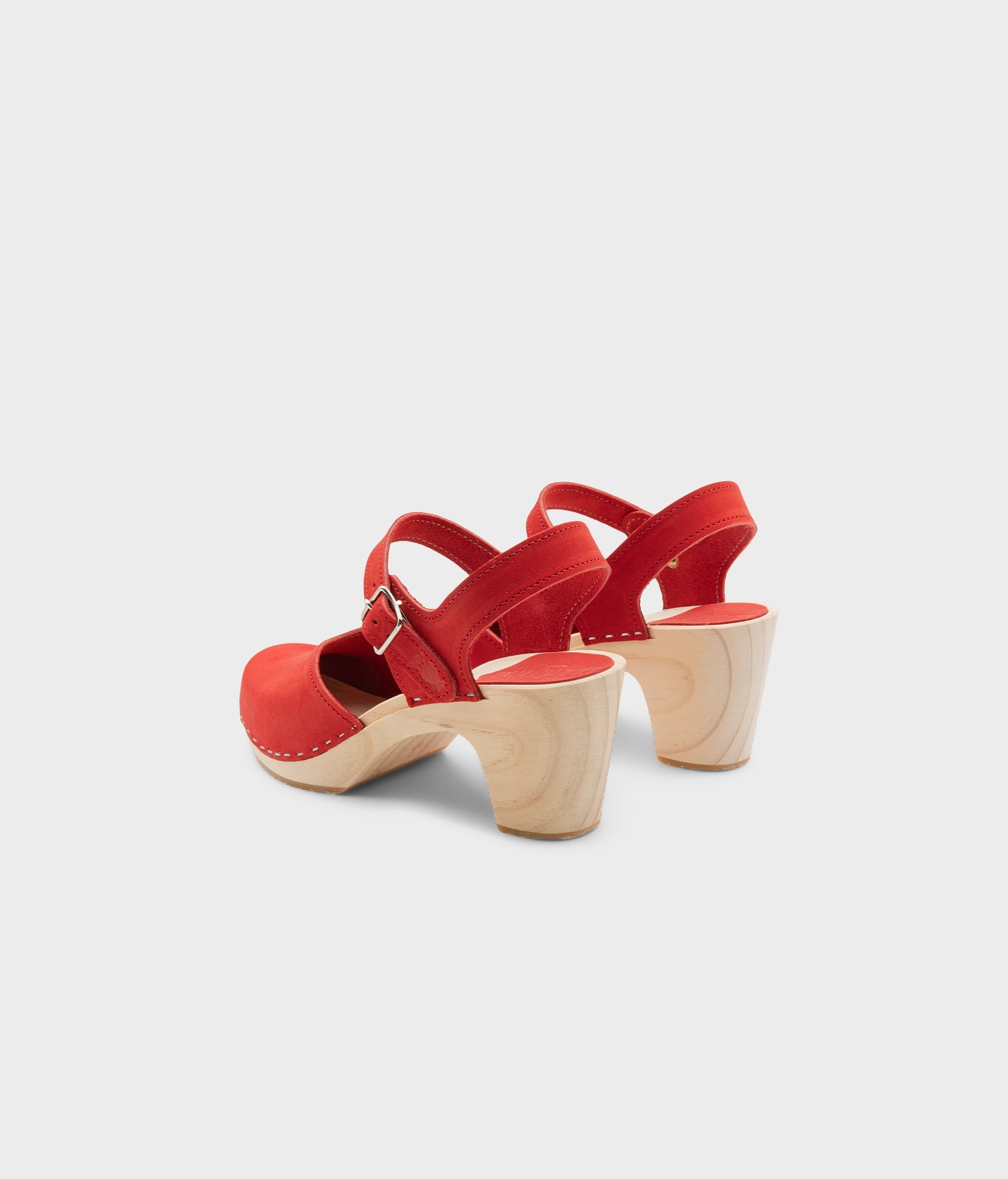High rise heel classic clog sandals in red nubuck leather stapled on a light wooden base