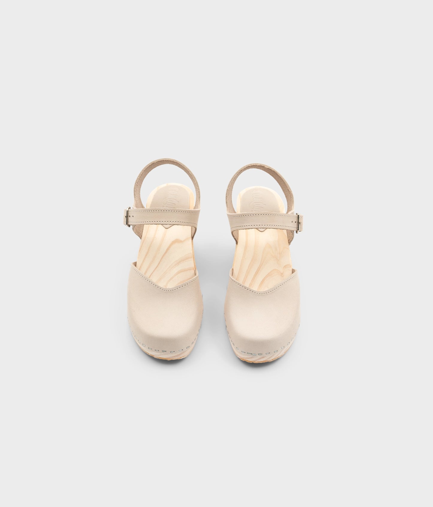 High rise heel classic clog sandals in sand white nubuck leather stapled on a light wooden base