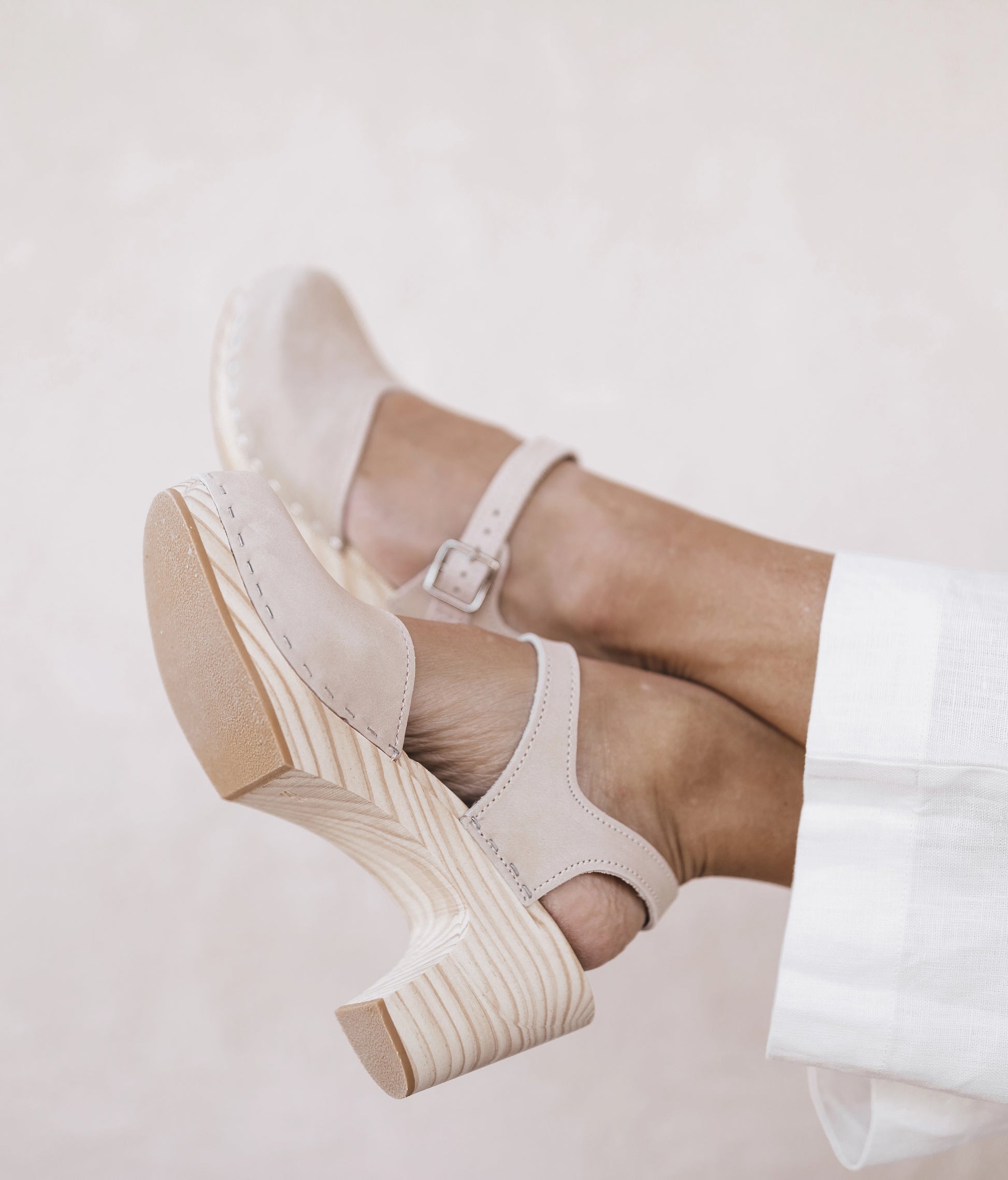 High rise heel classic clog sandals in sand white nubuck leather stapled on a light wooden base