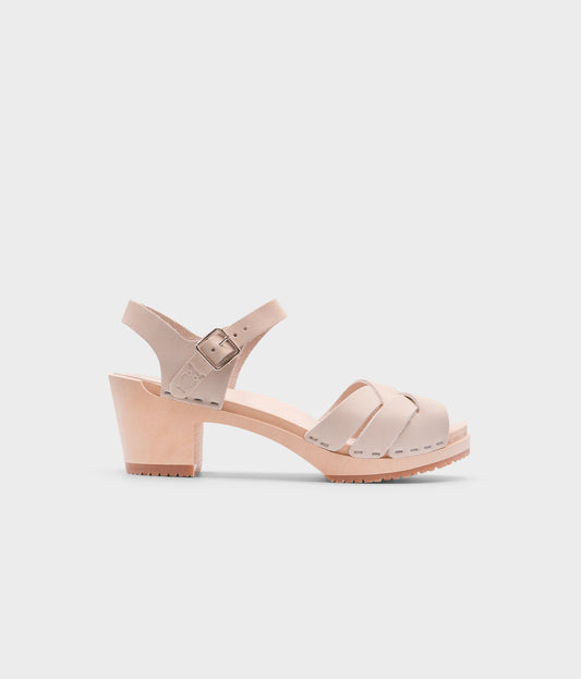 high heeled clog sandals in sand white nubuck leather with an open-toe stapled on a light wooden base