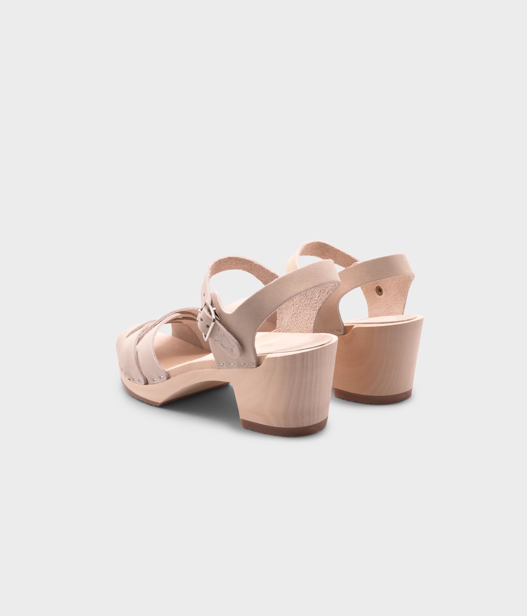 high heeled clog sandals in sand white nubuck leather with an open-toe stapled on a light wooden base