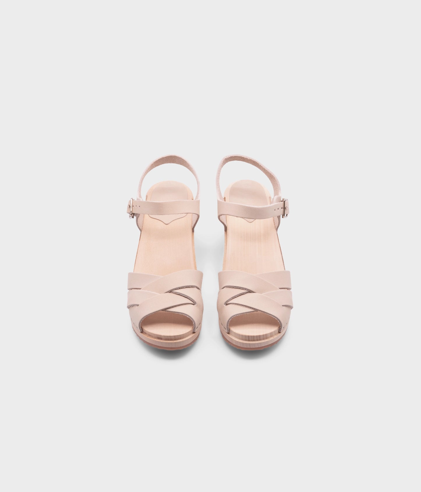high heeled clog sandals in sand white nubuck leather with an open-toe stapled on a light wooden base