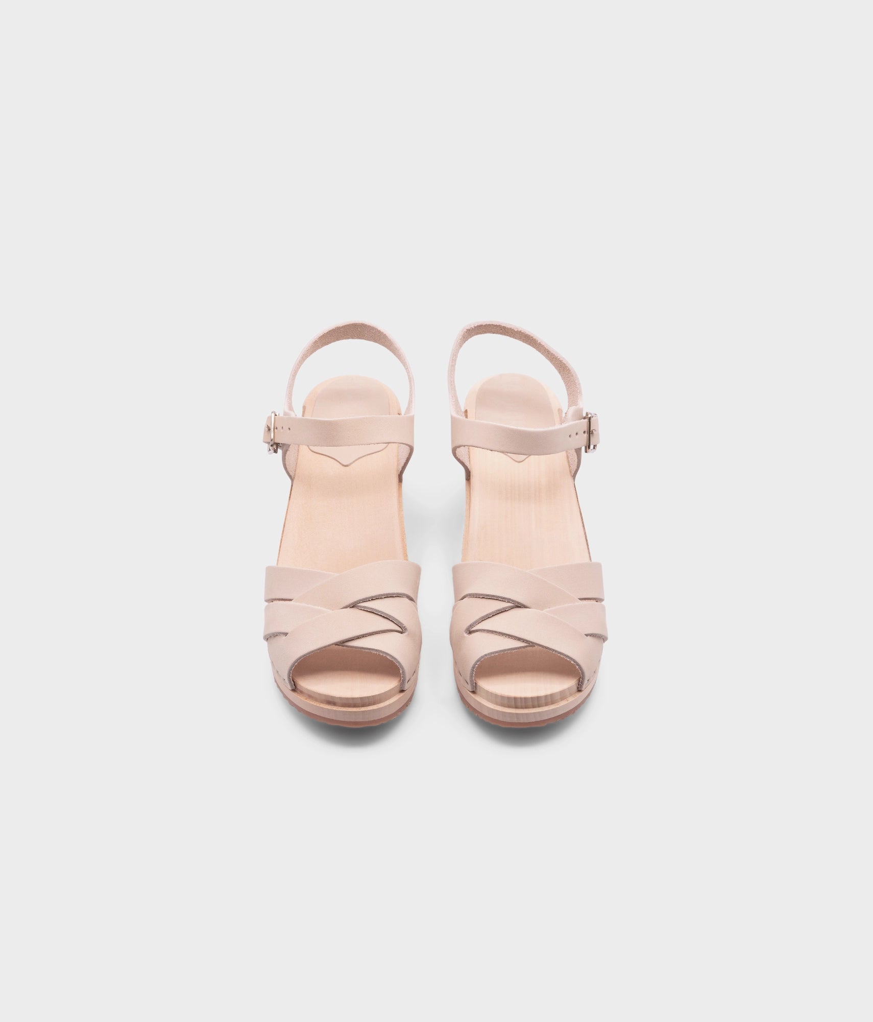 high heeled clog sandals in sand white nubuck leather with an open-toe stapled on a light wooden base