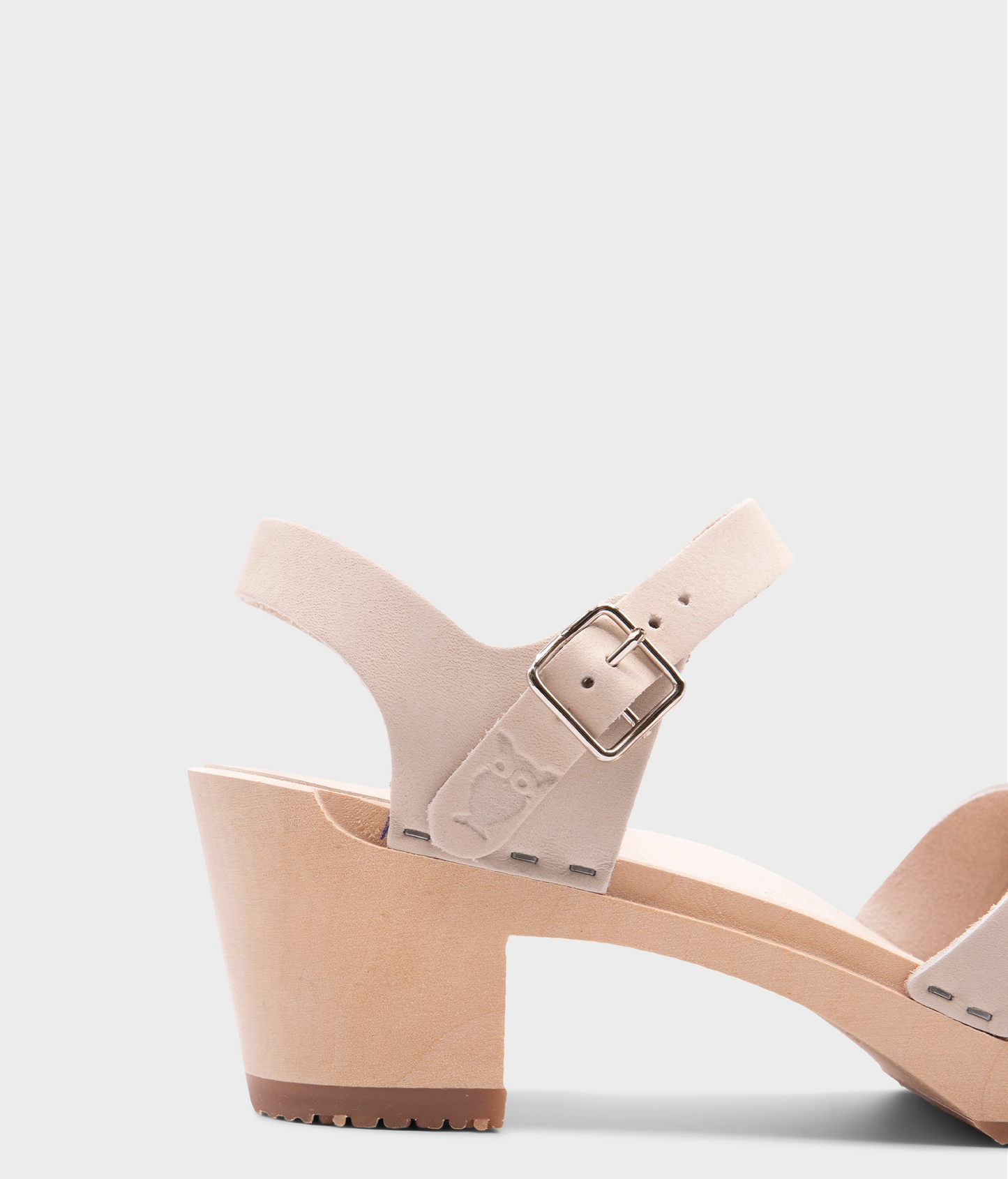 high heeled clog sandals in sand white nubuck leather with an open-toe stapled on a light wooden base