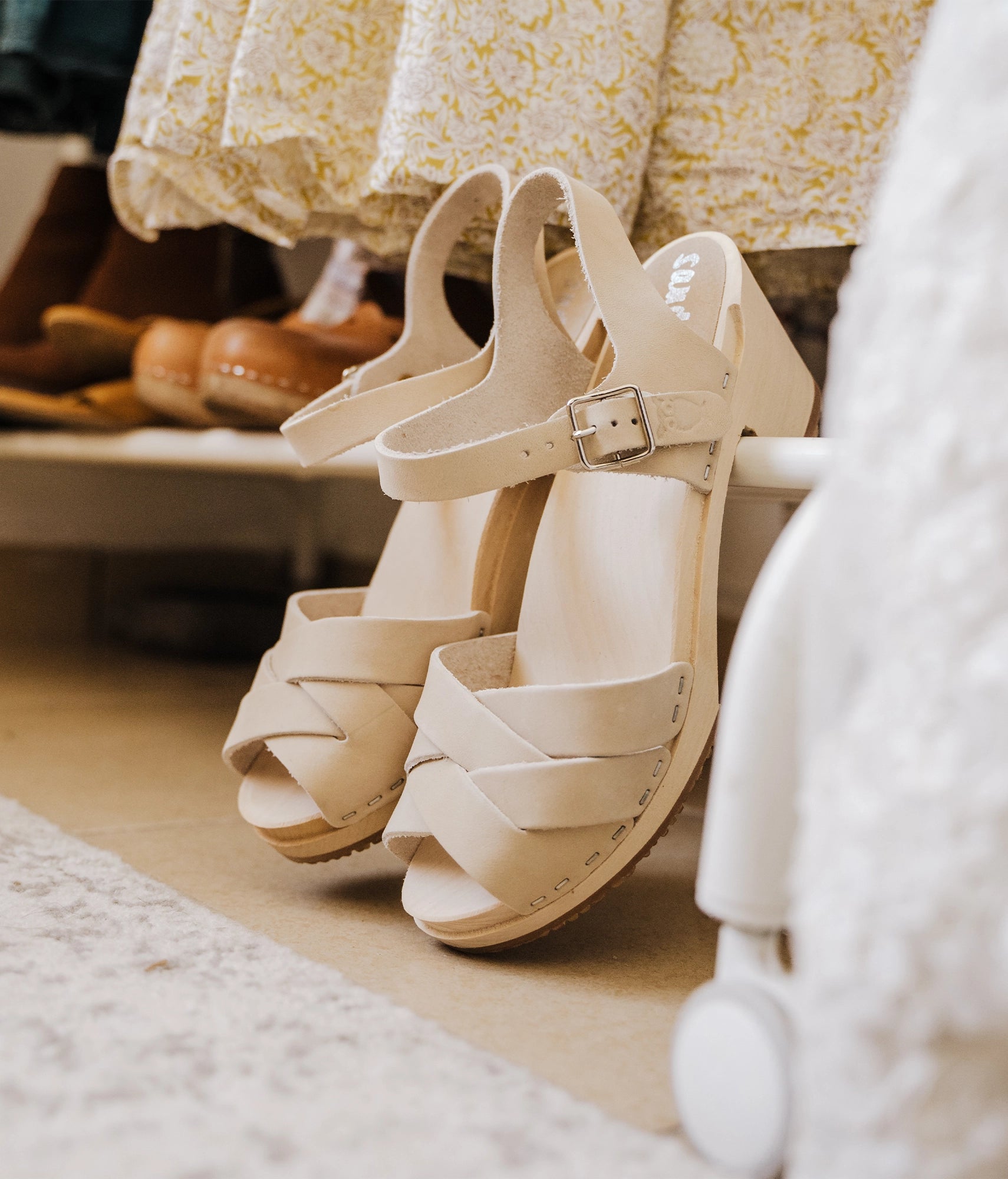 high heeled clog sandals in sand white nubuck leather with an open-toe stapled on a light wooden base