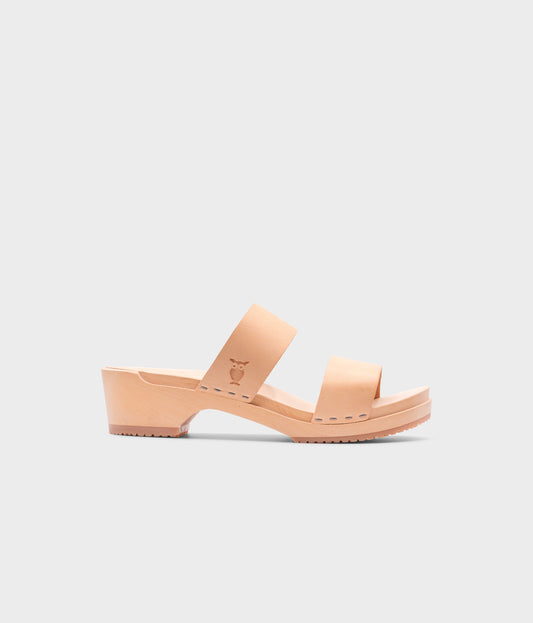 low heeled slip-in clog sandal with open toe in beige ecru vegetable tanned leather stapled on a light wooden base
