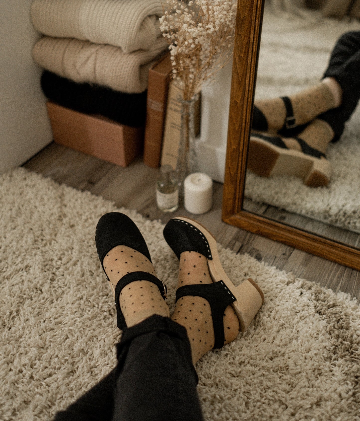 high heeled closed-toe clog sandal in black nubuck leather stapled on a light wooden base