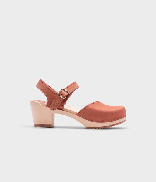 high heeled closed-toe clog sandal in blush pink nubuck leather stapled on a light wooden base