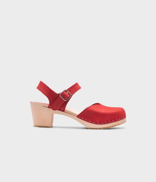 high heeled closed-toe clog sandal in red nubuck leather stapled on a light wooden base
