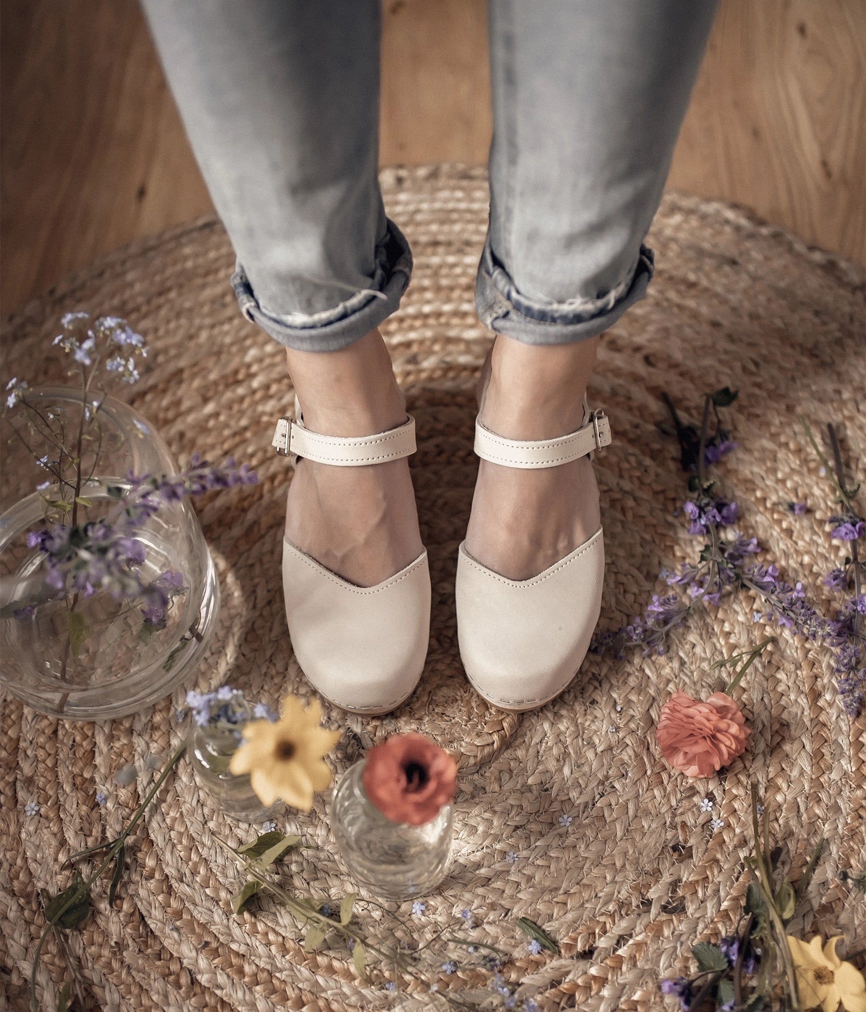 high heeled closed-toe clog sandal in sand white nubuck leather stapled on a light wooden base