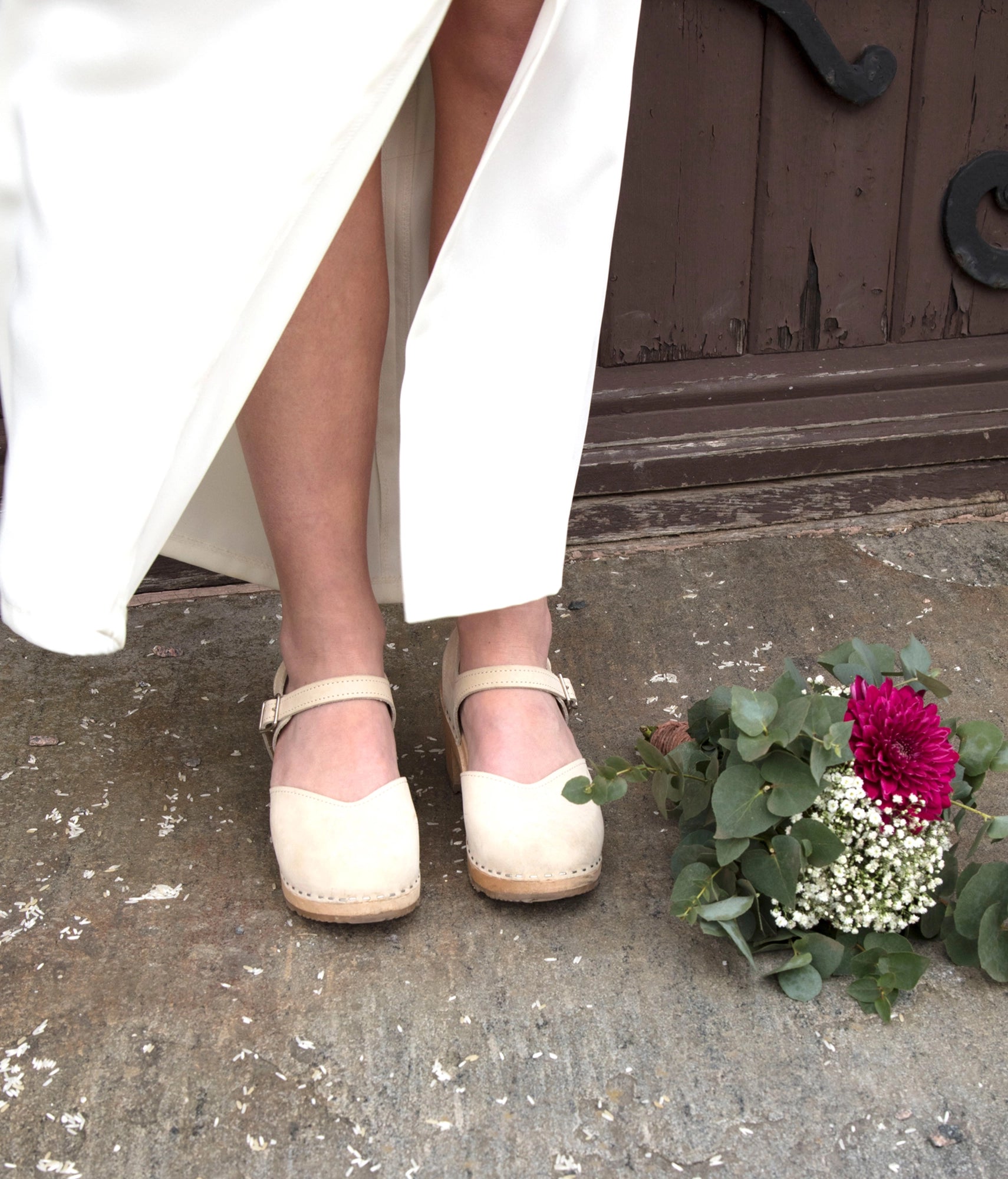 high heeled closed-toe clog sandal in sand white nubuck leather stapled on a light wooden base