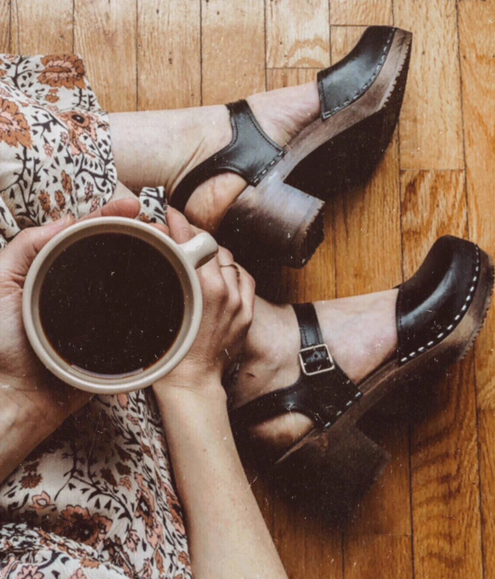 high heeled closed-toe clog sandal in black vegetable tanned leather stapled on a dark wooden base