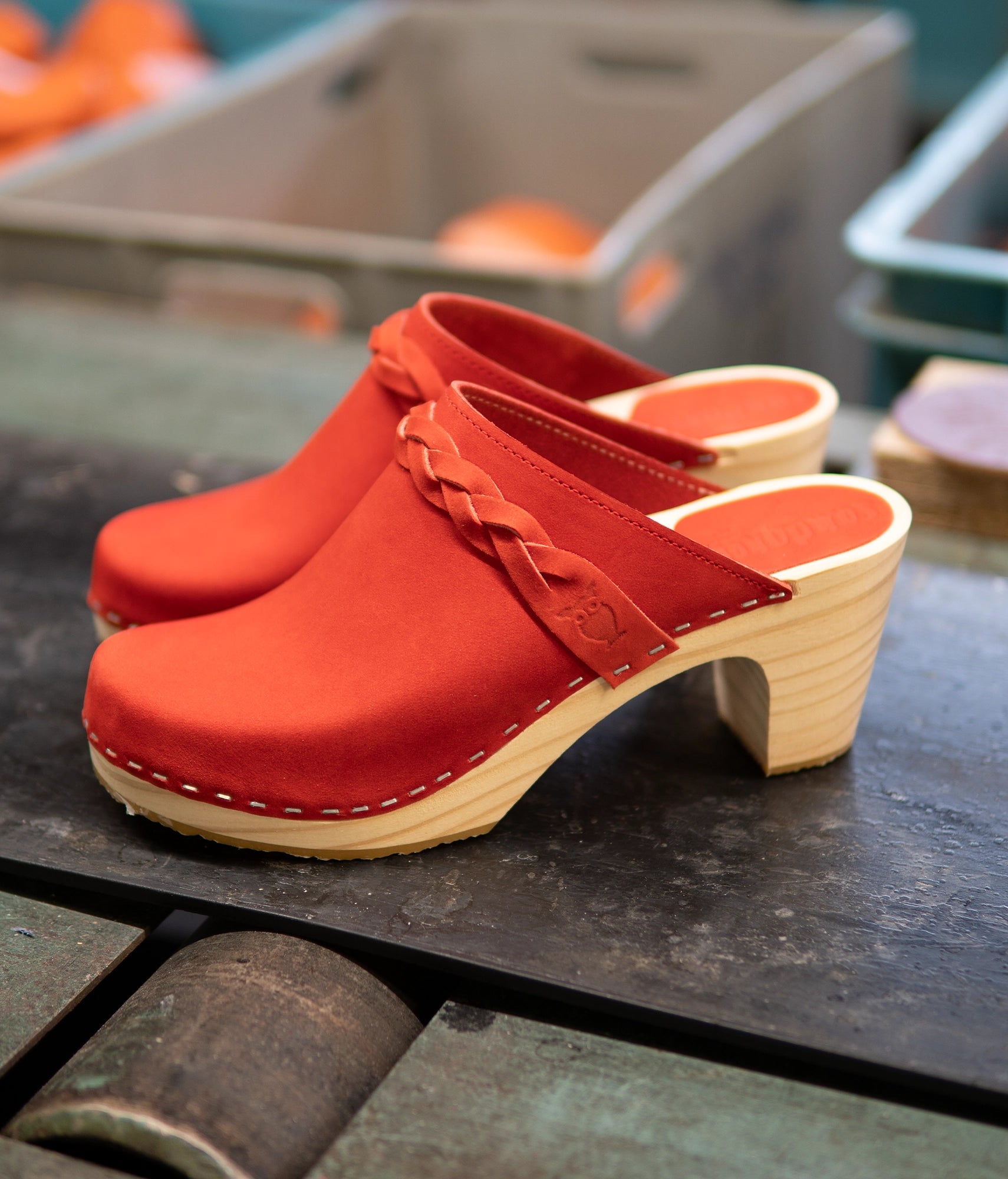 high rise heel braided clog mule in red nubuck leather stapled on a light wooden base