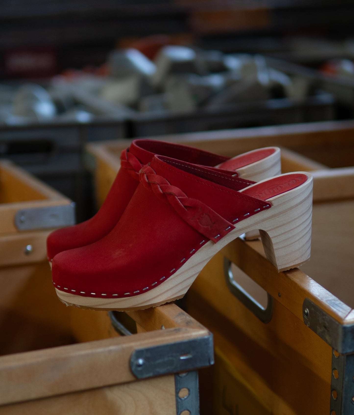 high rise heel braided clog mule in red nubuck leather stapled on a light wooden base