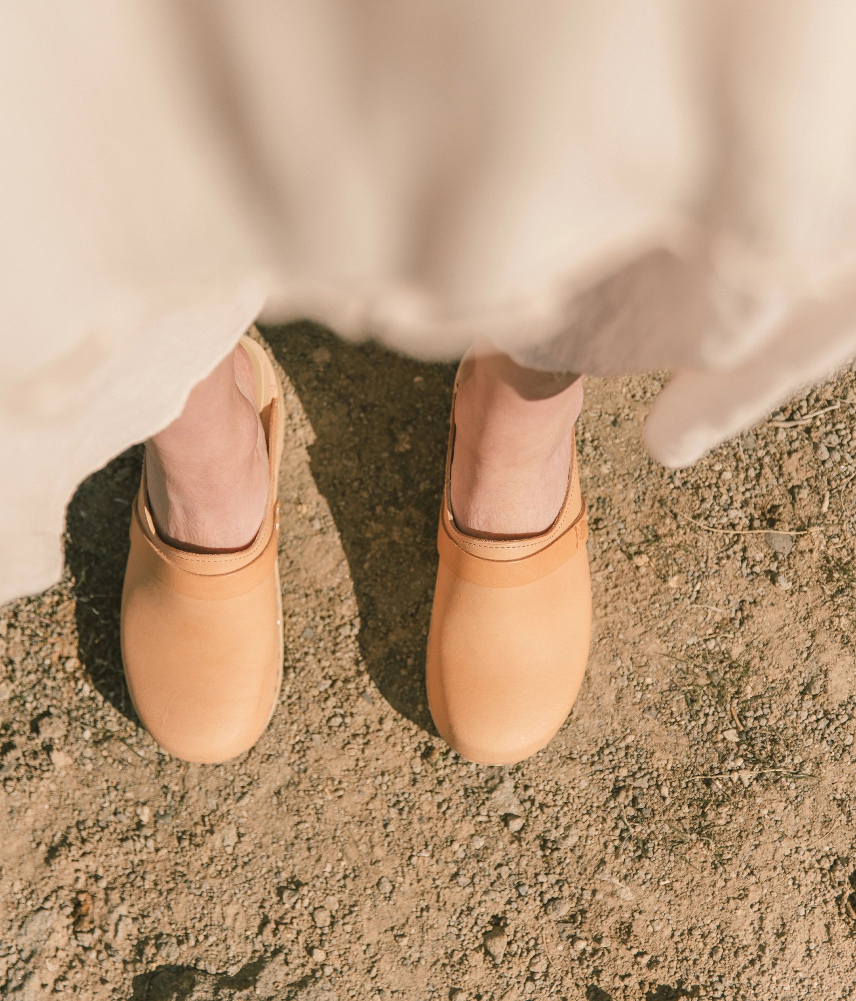 classic low heeled clog mule in beige ecru vegetable tanned leather stapled on a light wooden base with a leather strap