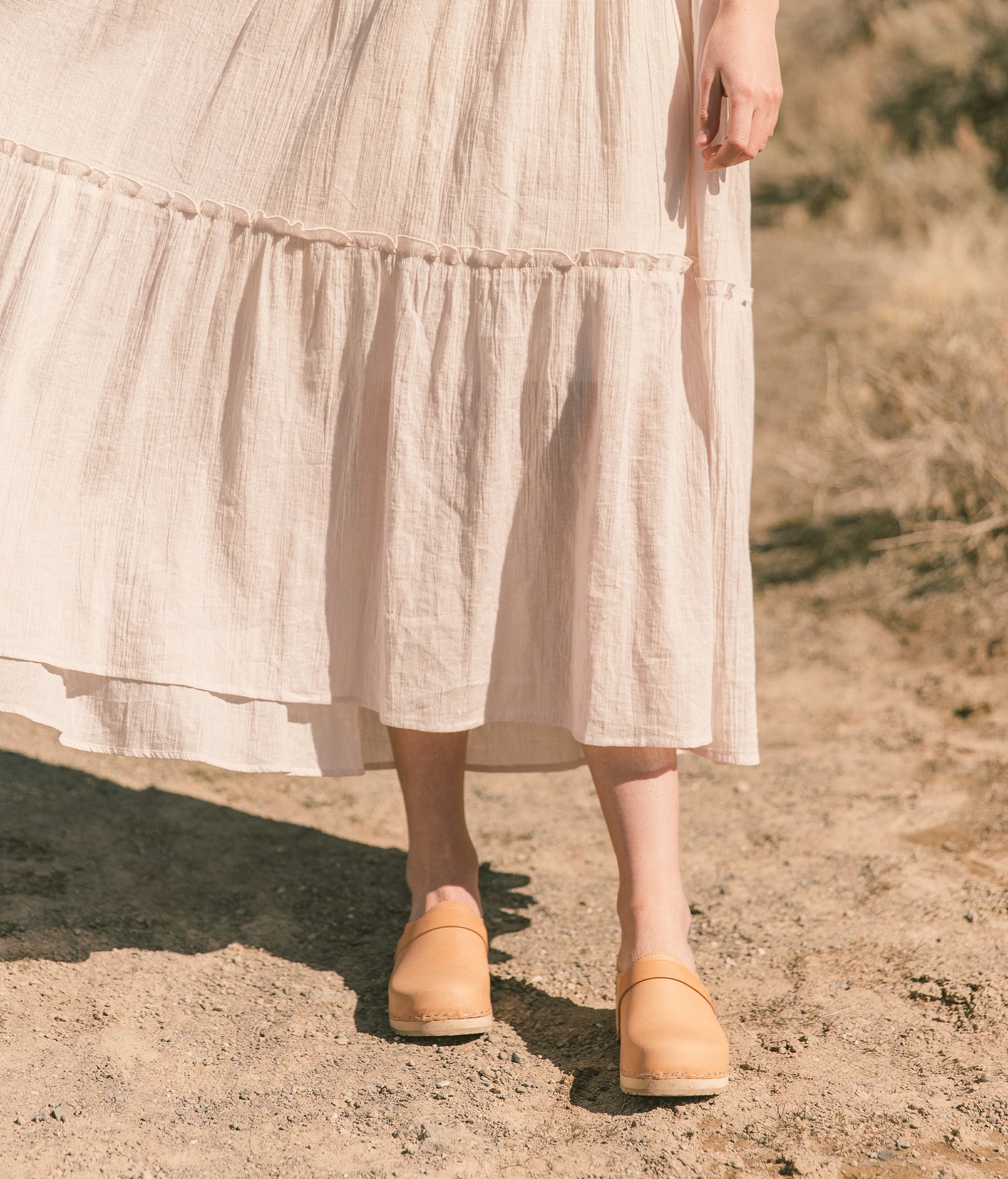 classic low heeled clog mule in beige ecru vegetable tanned leather stapled on a light wooden base with a leather strap