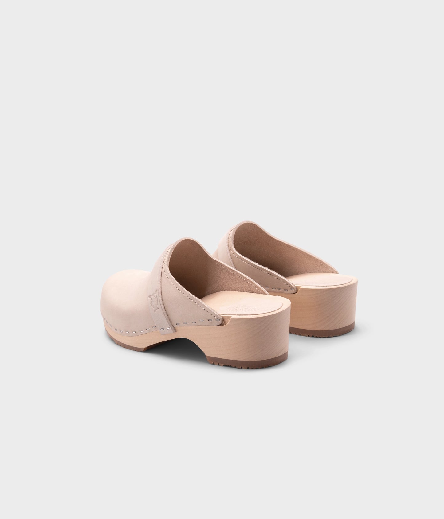 classic low heeled clog mule in sand white nubuck leather stapled on a light wooden base with a leather strap
