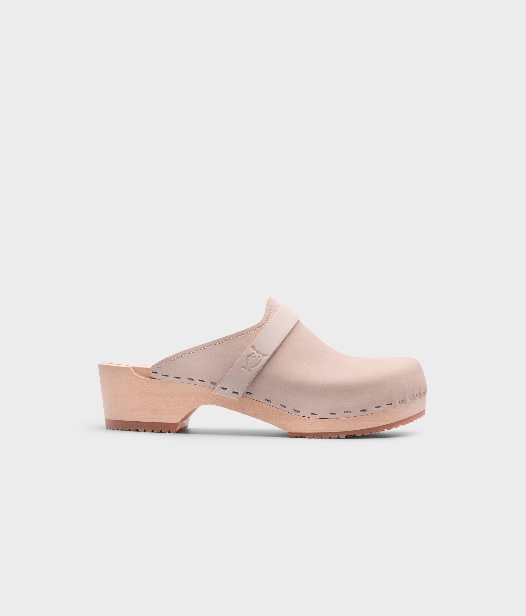 classic low heeled clog mule in sand white nubuck leather stapled on a light wooden base with a leather strap