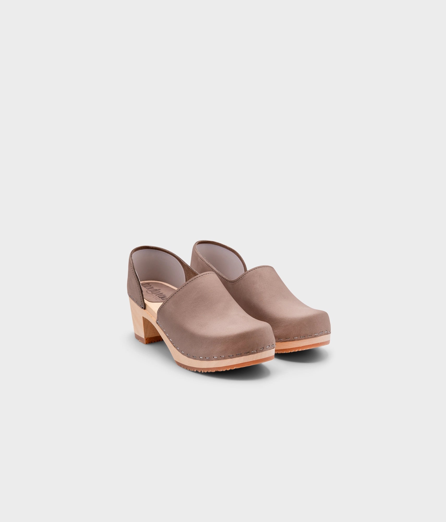 high heeled closed-back clogs in stone grey nubuck leather stapled on a light wooden base