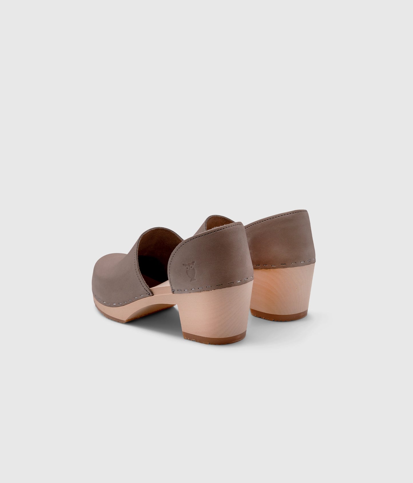 high heeled closed-back clogs in stone grey nubuck leather stapled on a light wooden base