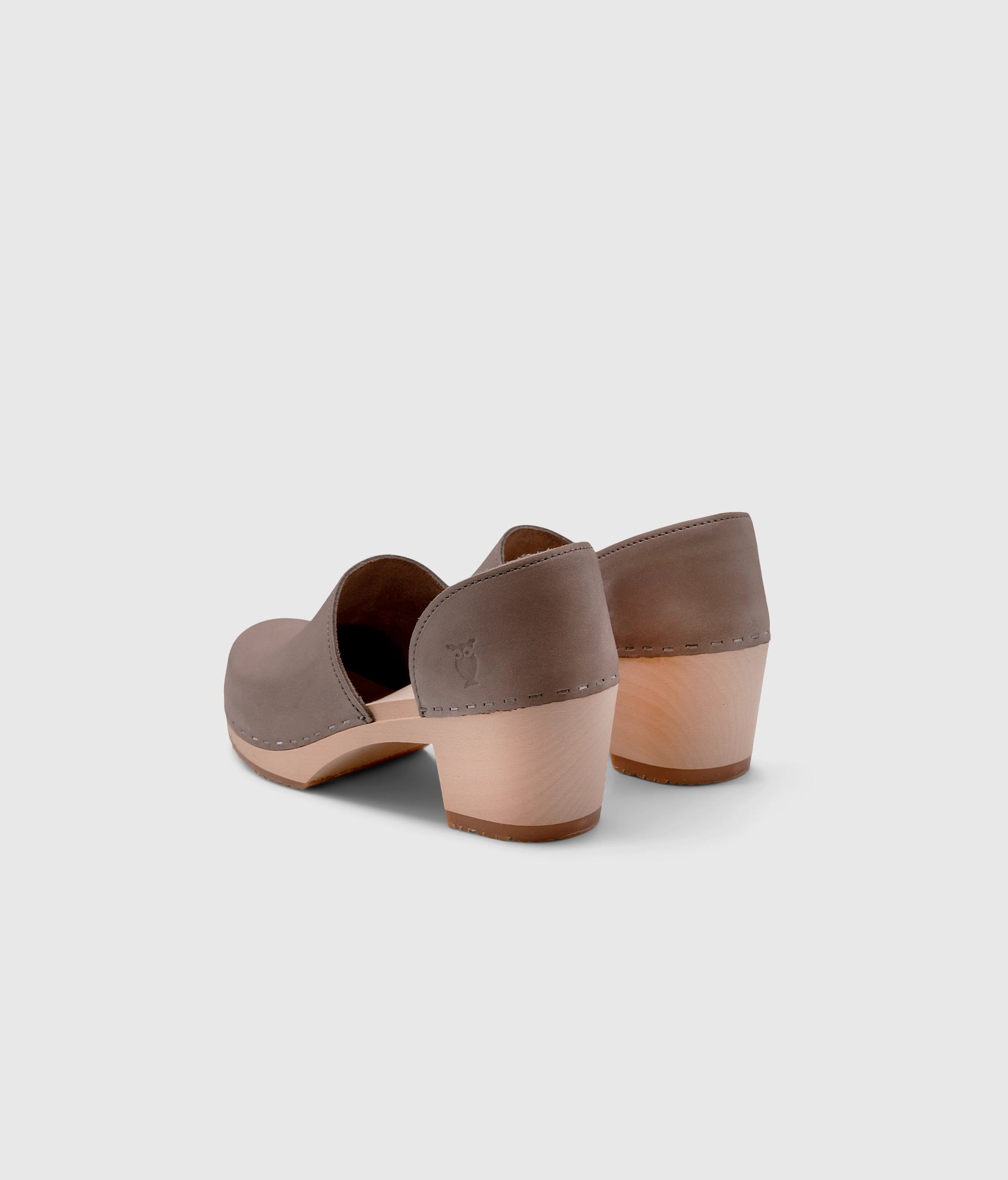high heeled closed-back clogs in stone grey nubuck leather stapled on a light wooden base