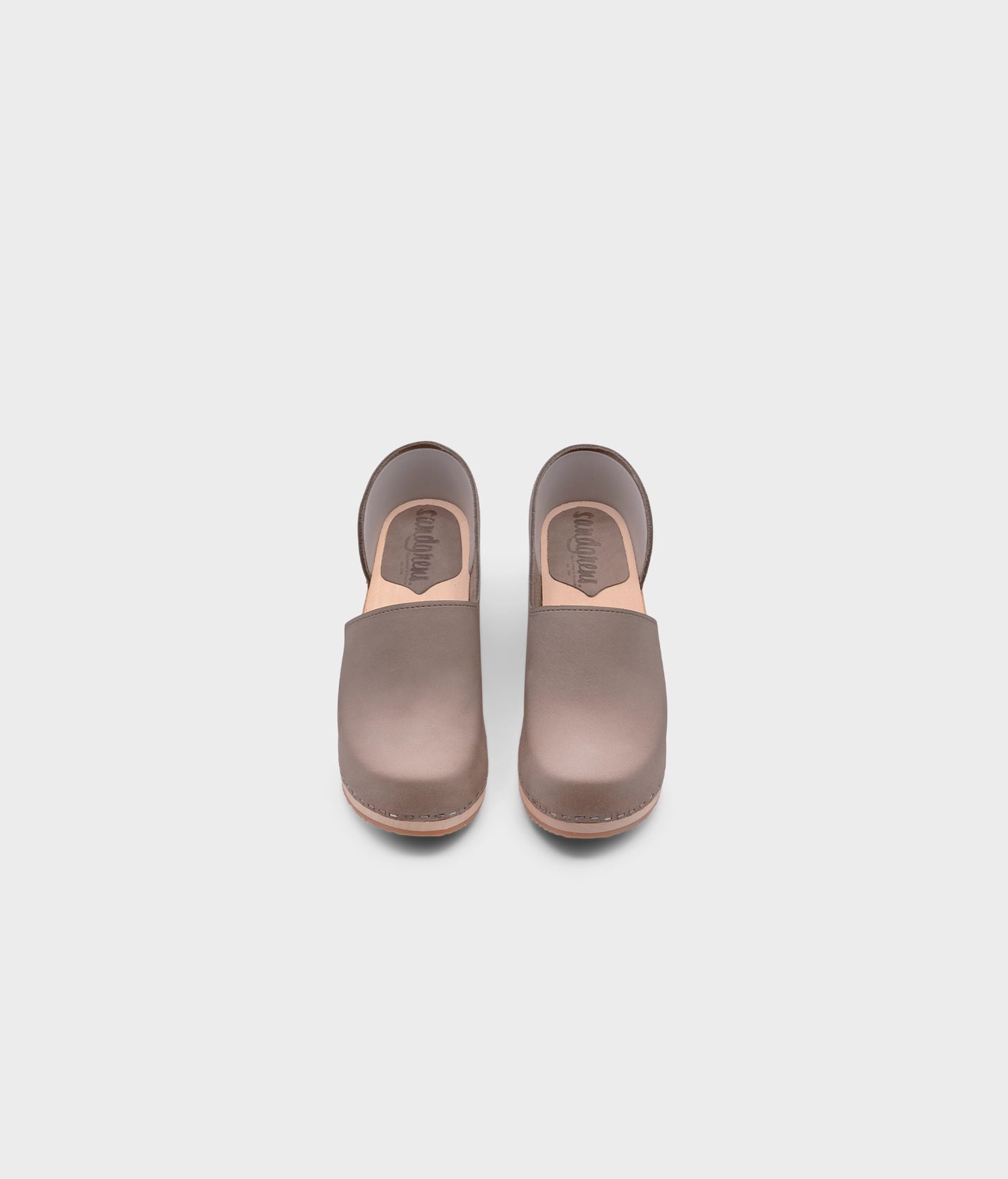 high heeled closed-back clogs in stone grey nubuck leather stapled on a light wooden base